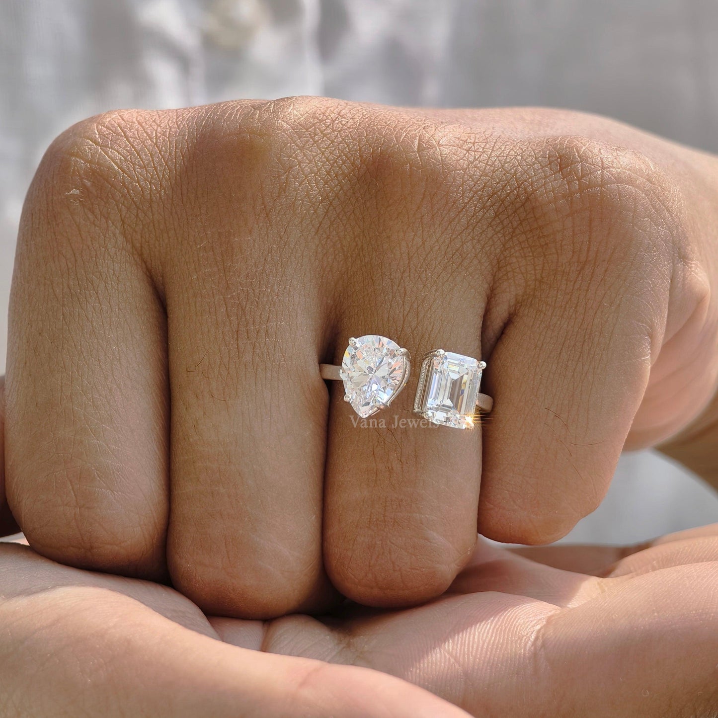 Solid gold toi et moi ring featuring emerald and pear cut moissanite