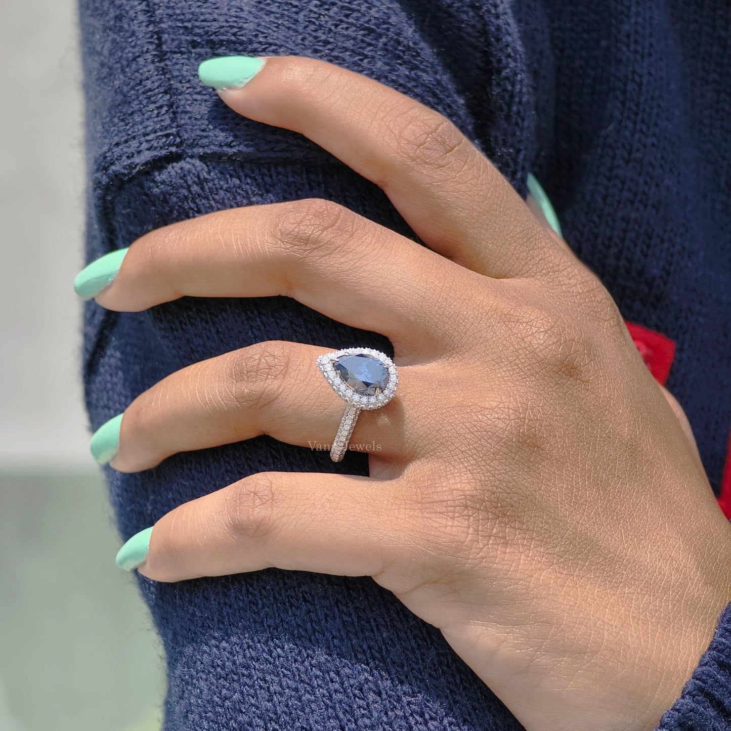 Royal blue pear moissanite halo and pave ring