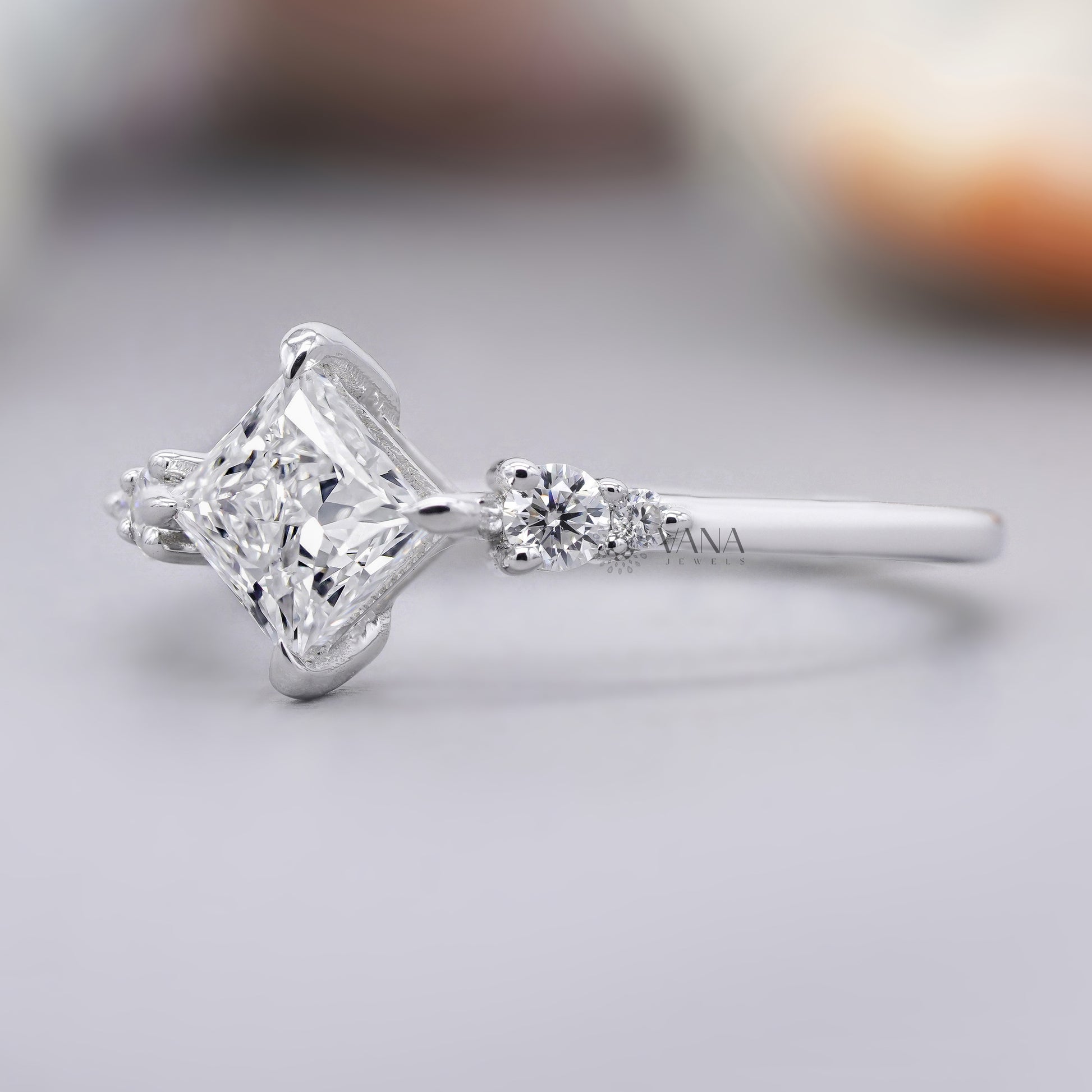 Princess cut moissanite engagement ring with round side stones
