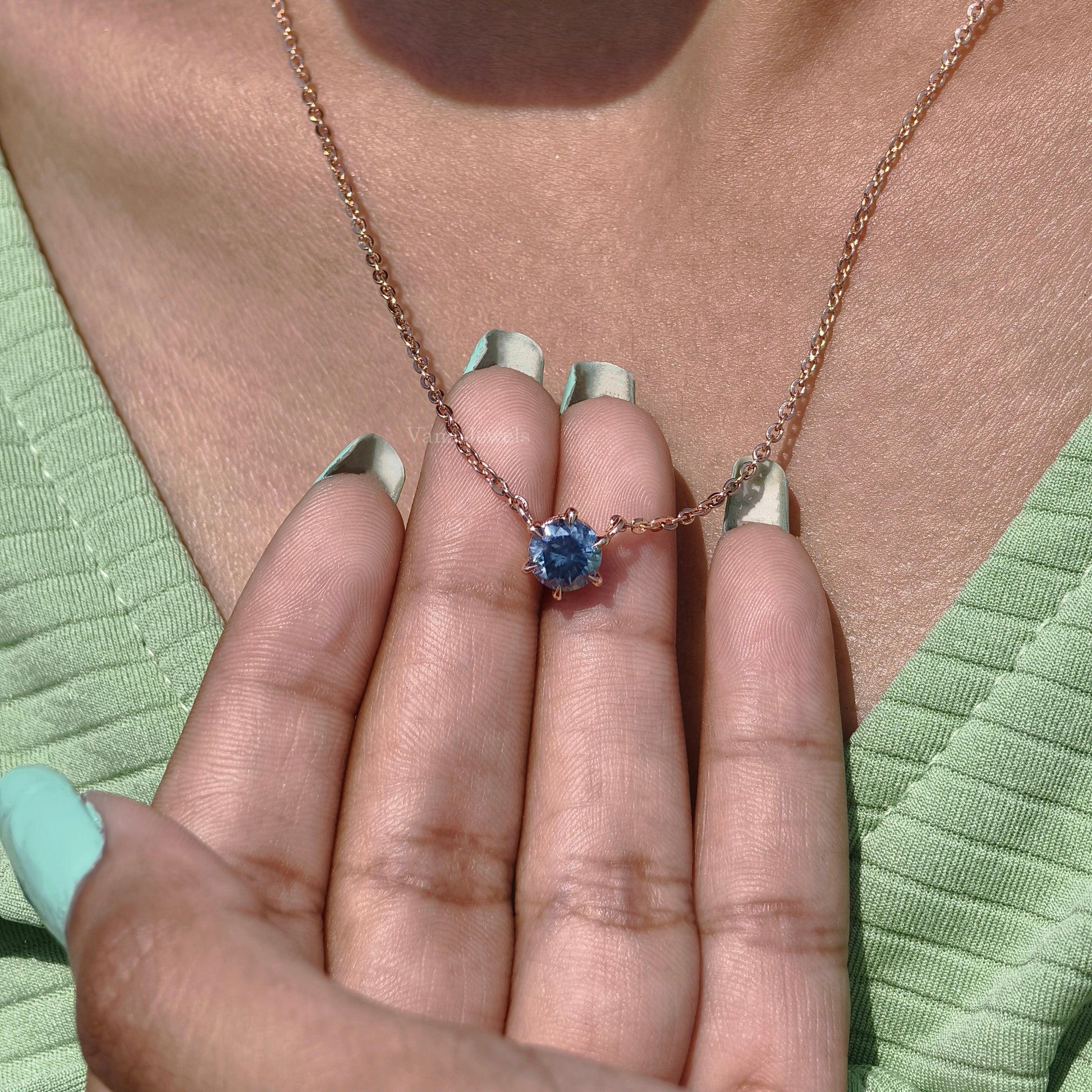 Gold solitaire necklace with round cut blue moissanite