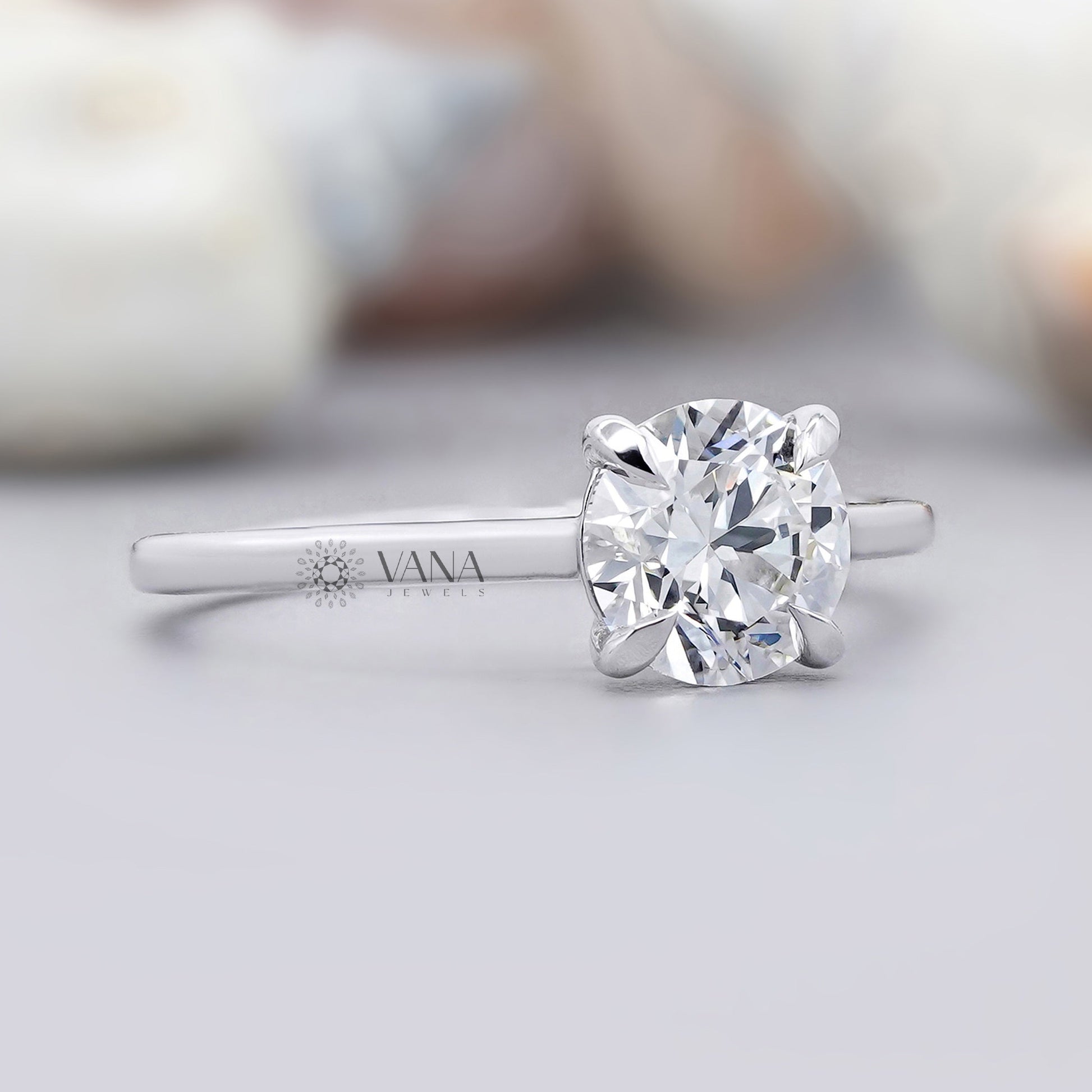 Silver ring with a large diamond on a light gray background