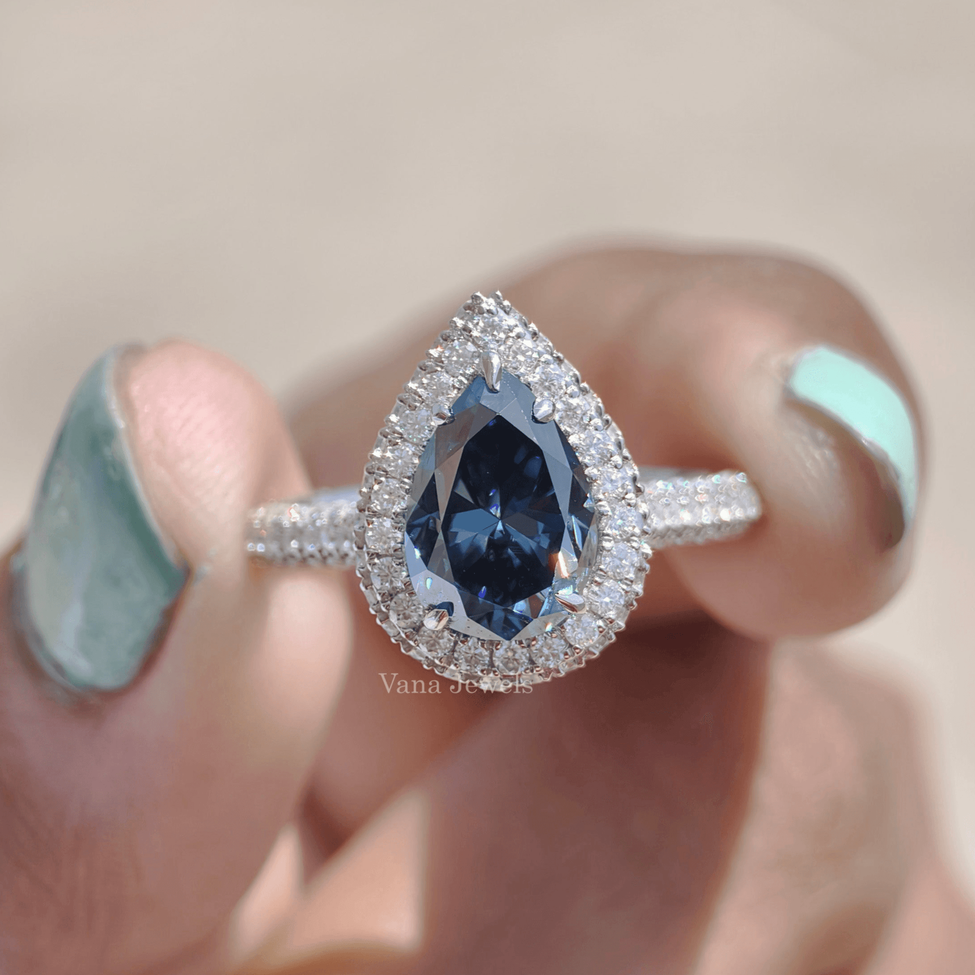 Royal blue pear moissanite halo and pave set engagement ring