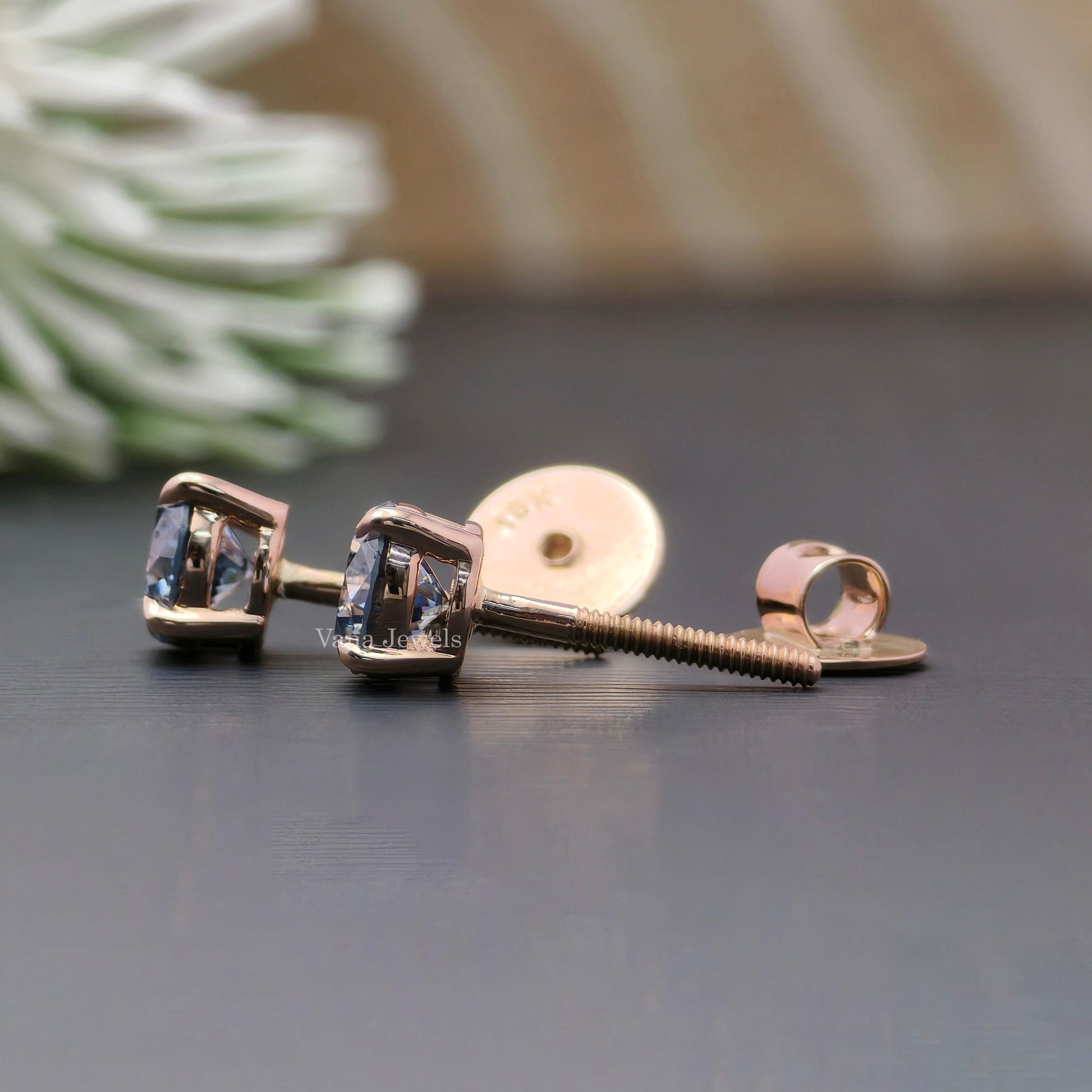 Royal blue moissanite stud earrings with round cut stones in rose gold