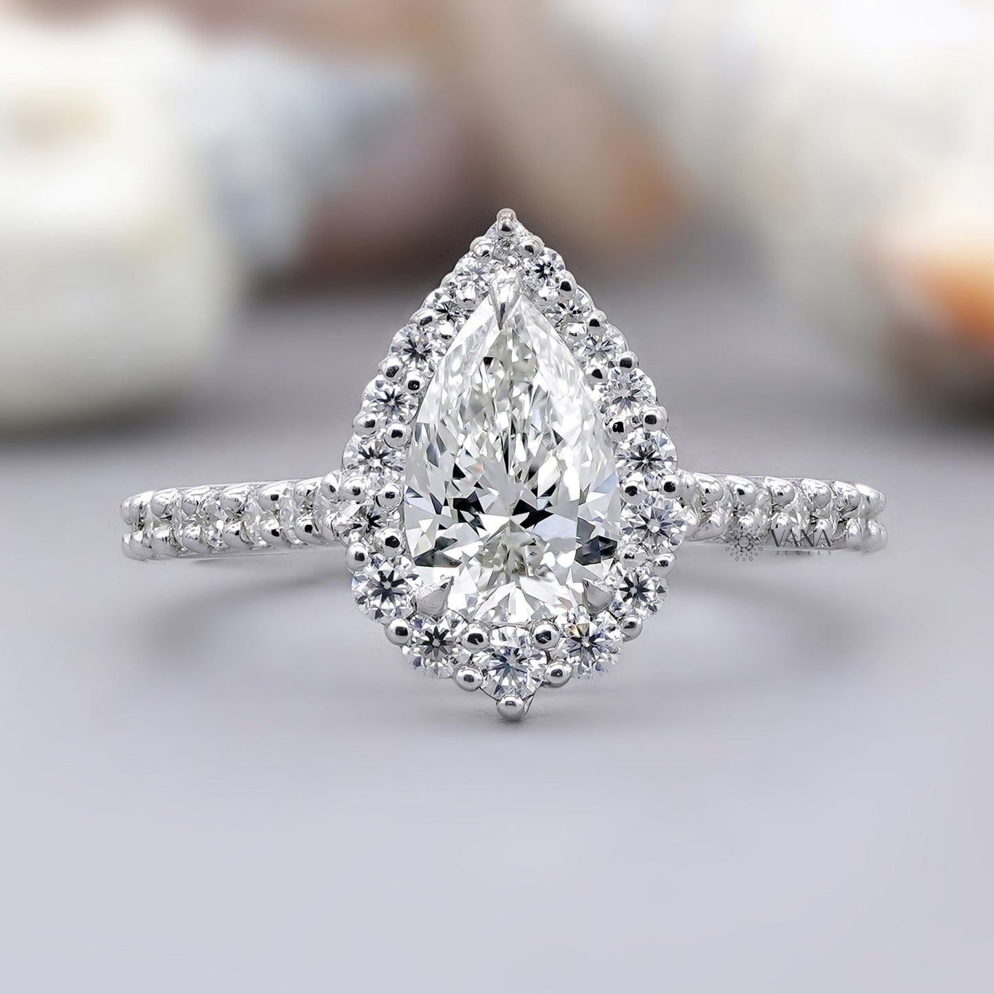Pear cut moissanite halo engagement ring with pave setting in white gold