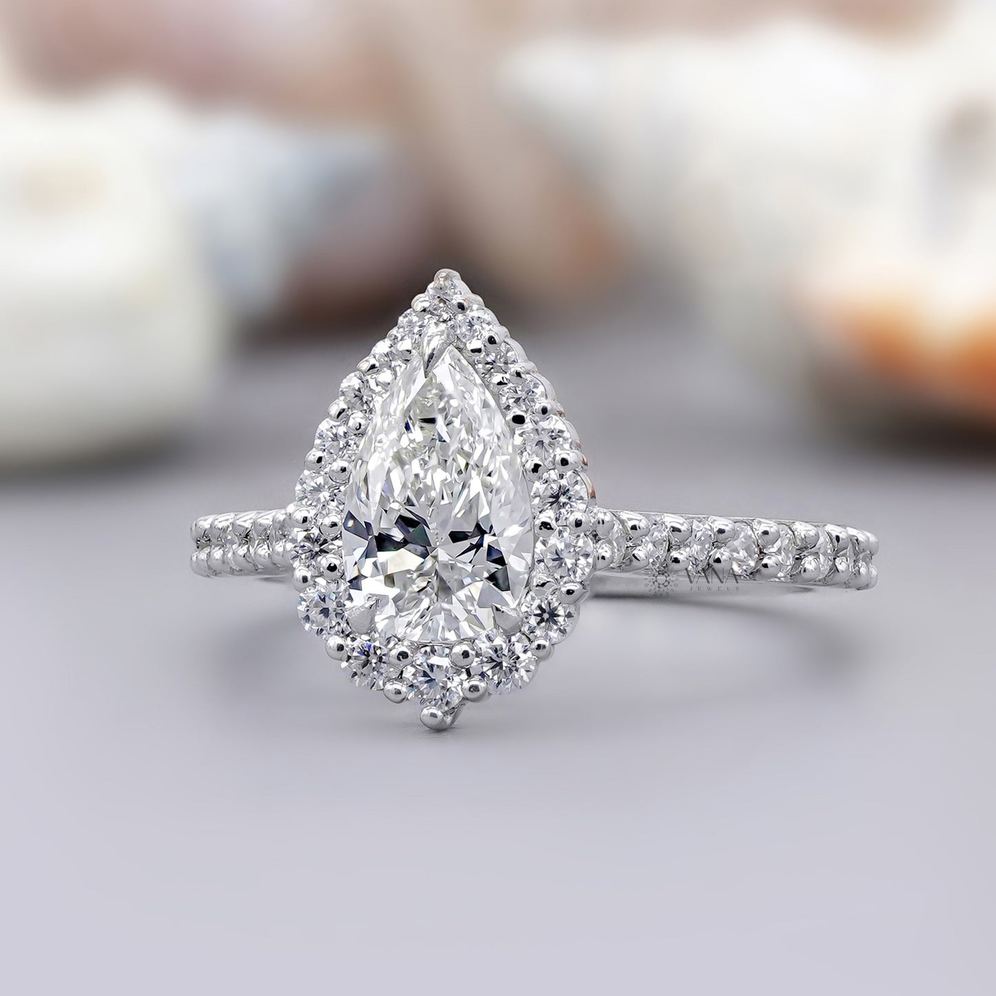Teardrop moissanite ring with brilliant halo and white gold band