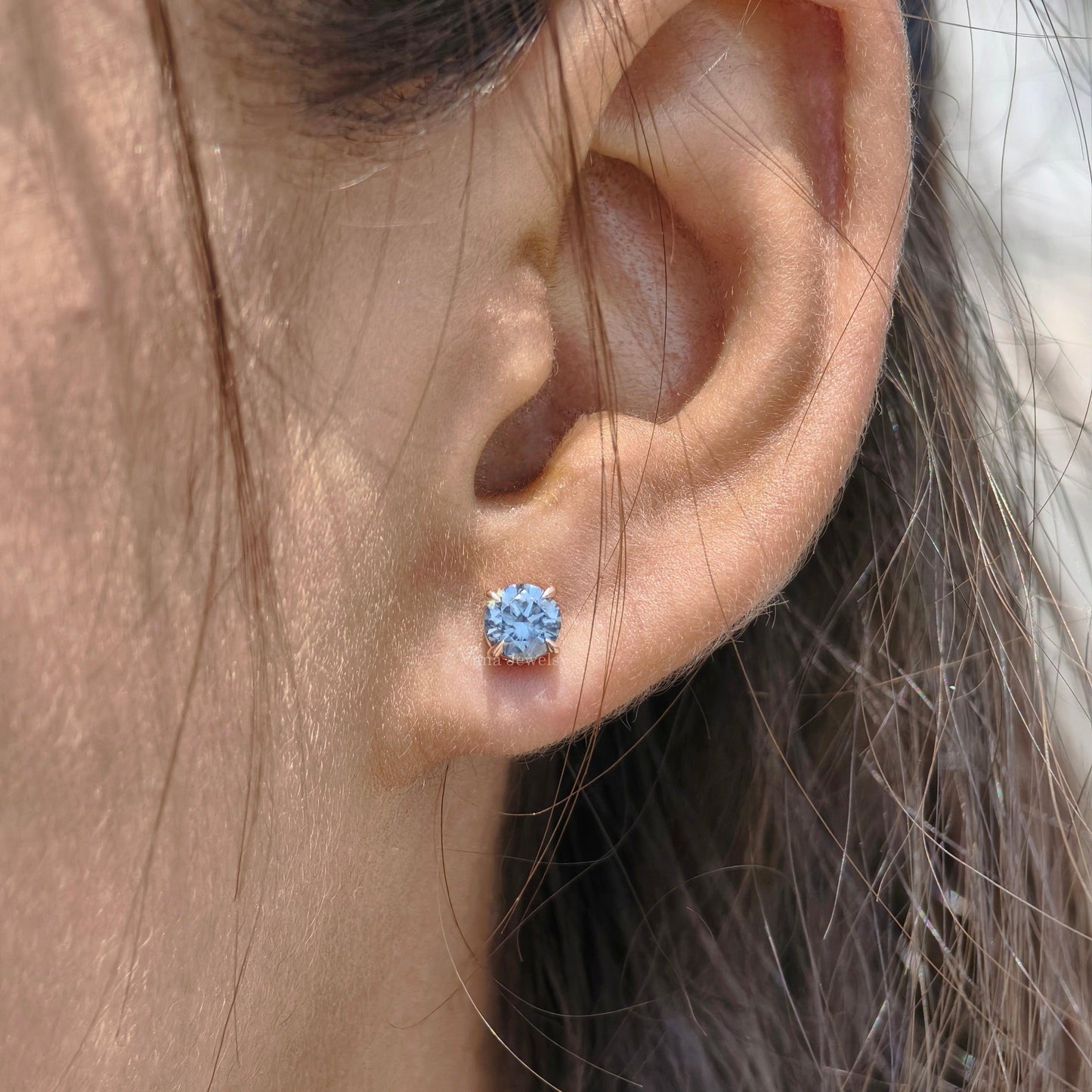 Royal blue moissanite stud earrings with round cut stones in rose gold