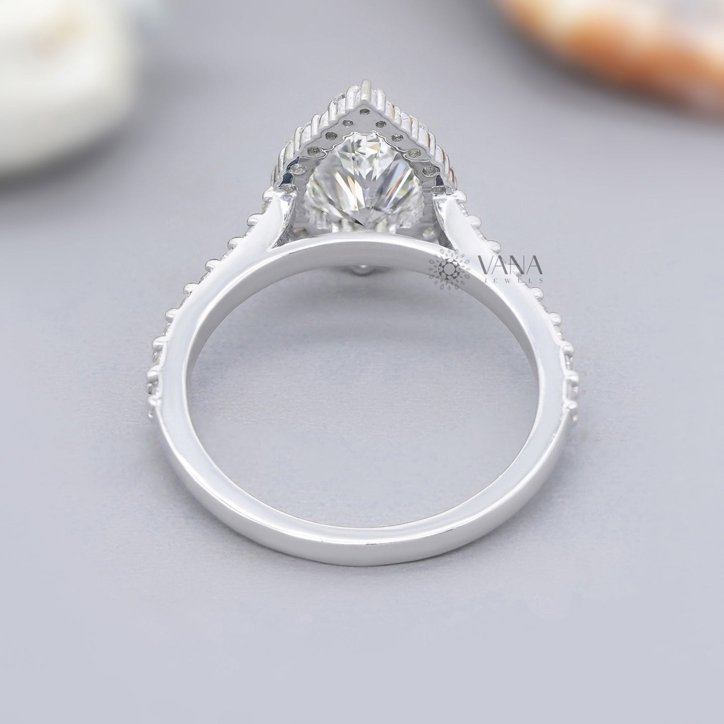 Silver ring with a diamond on a gray surface