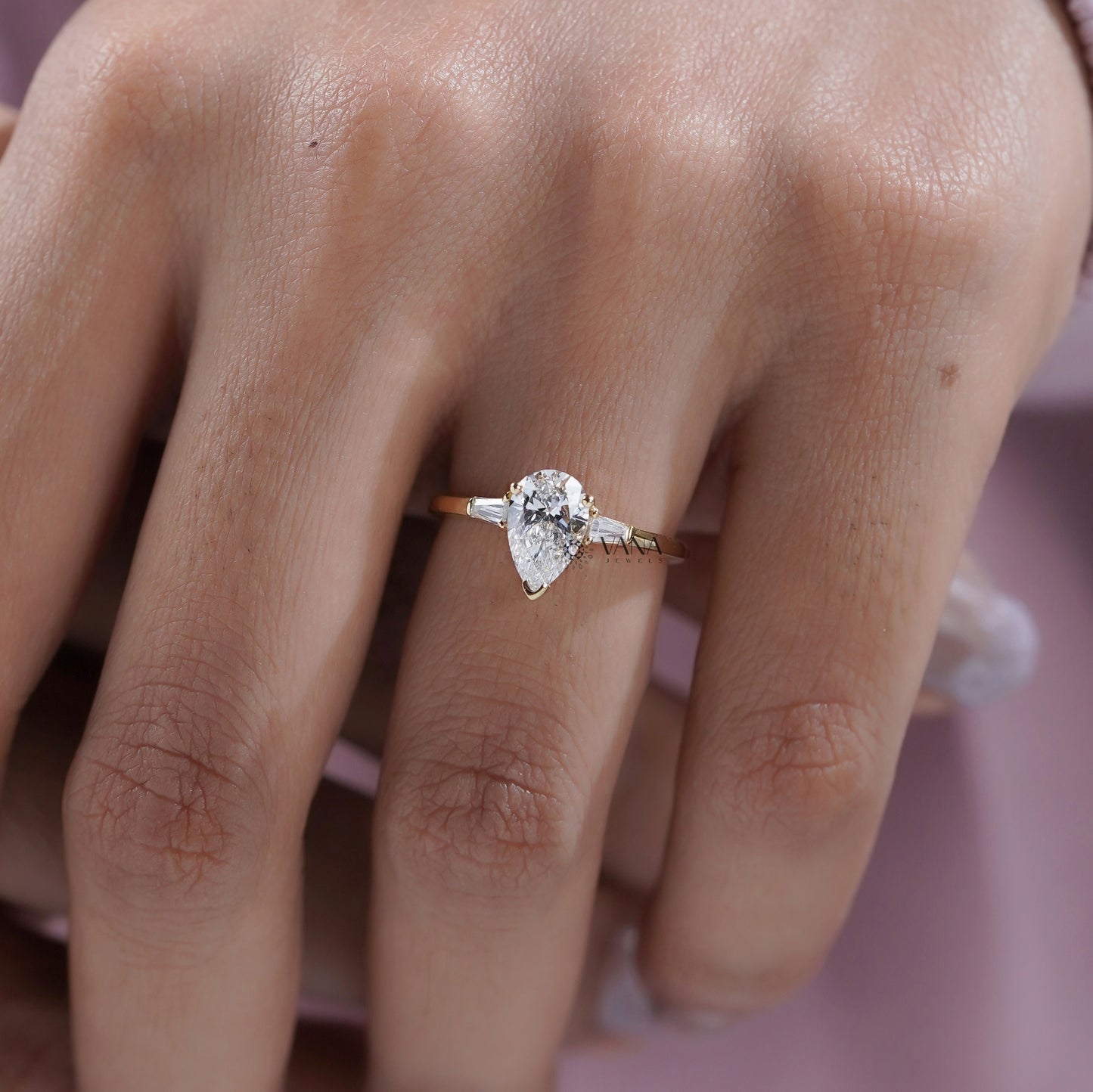 Three stone engagement ring with pear and baguette diamonds