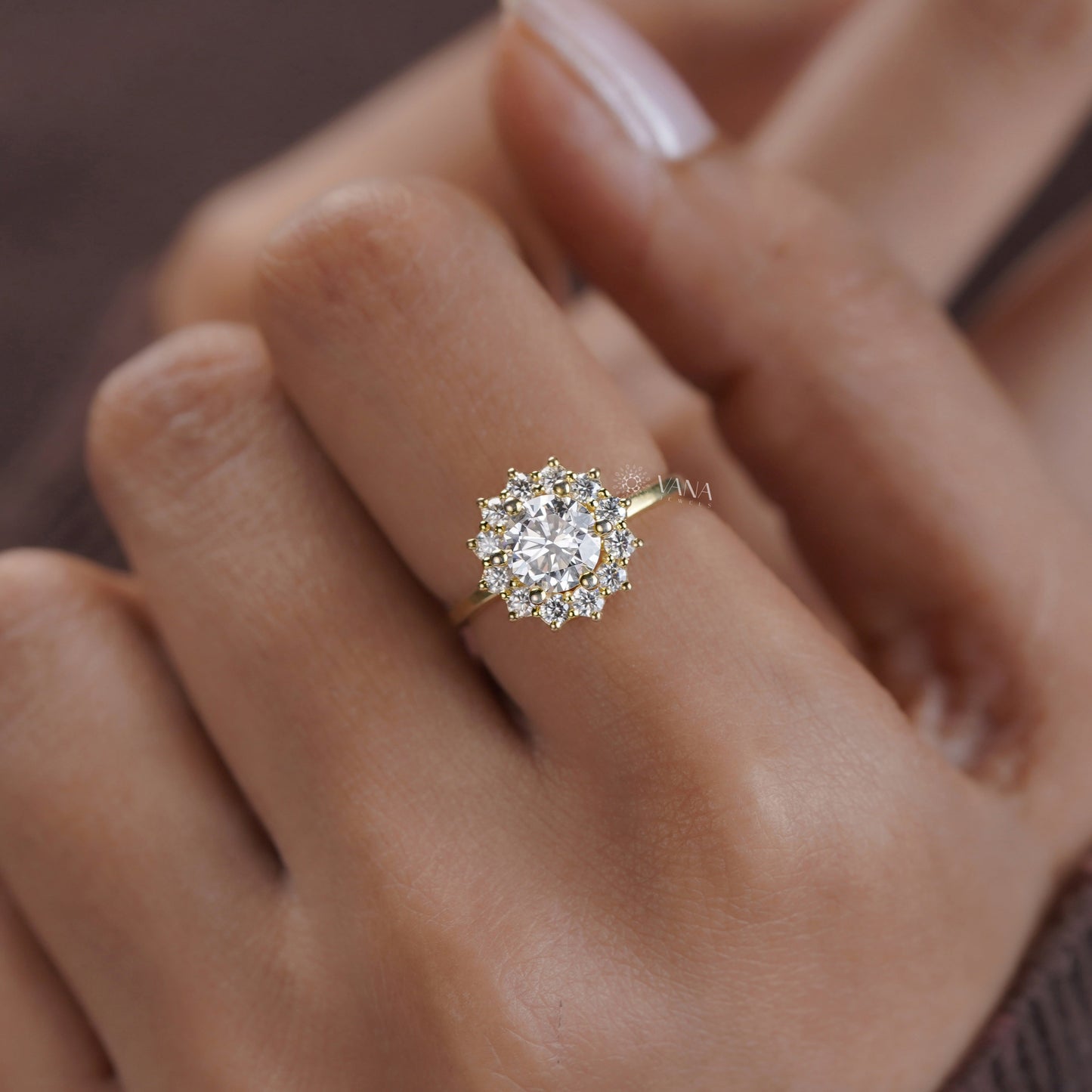 Round center stone engagement ring with dainty flower-shaped halo