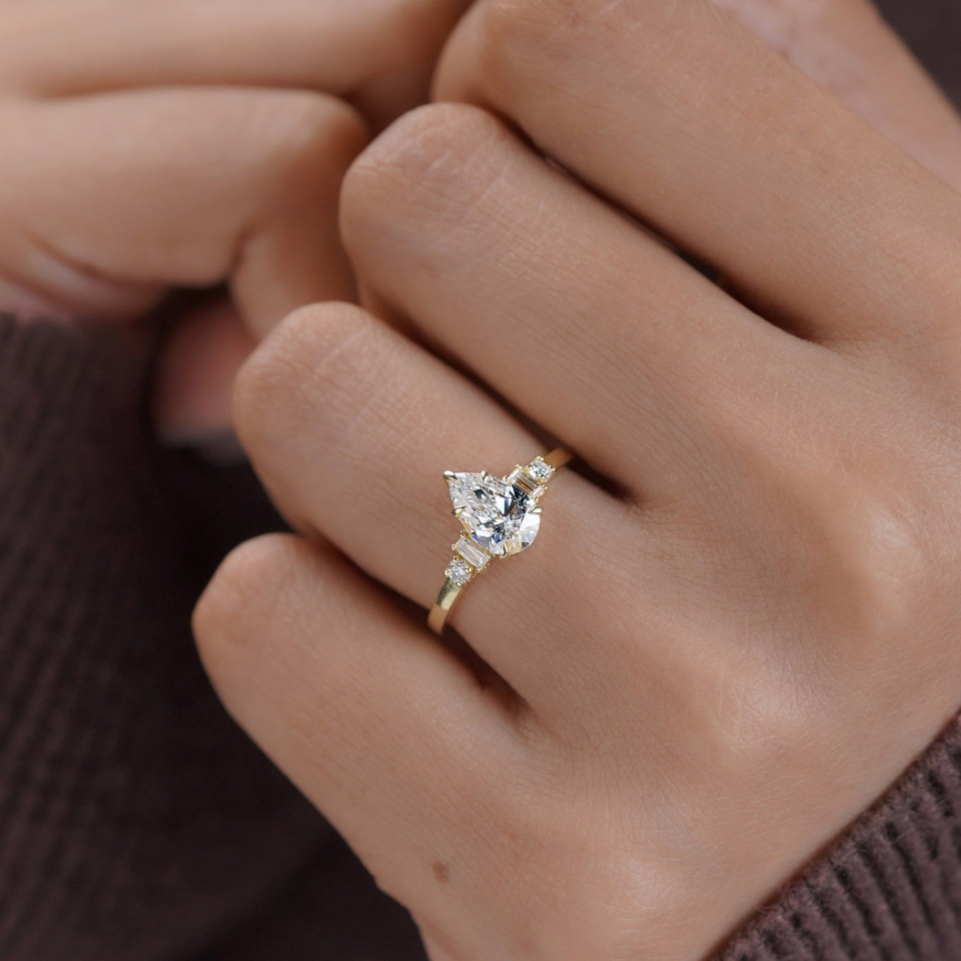 Three-stone moissanite ring with pear center and vintage side stones