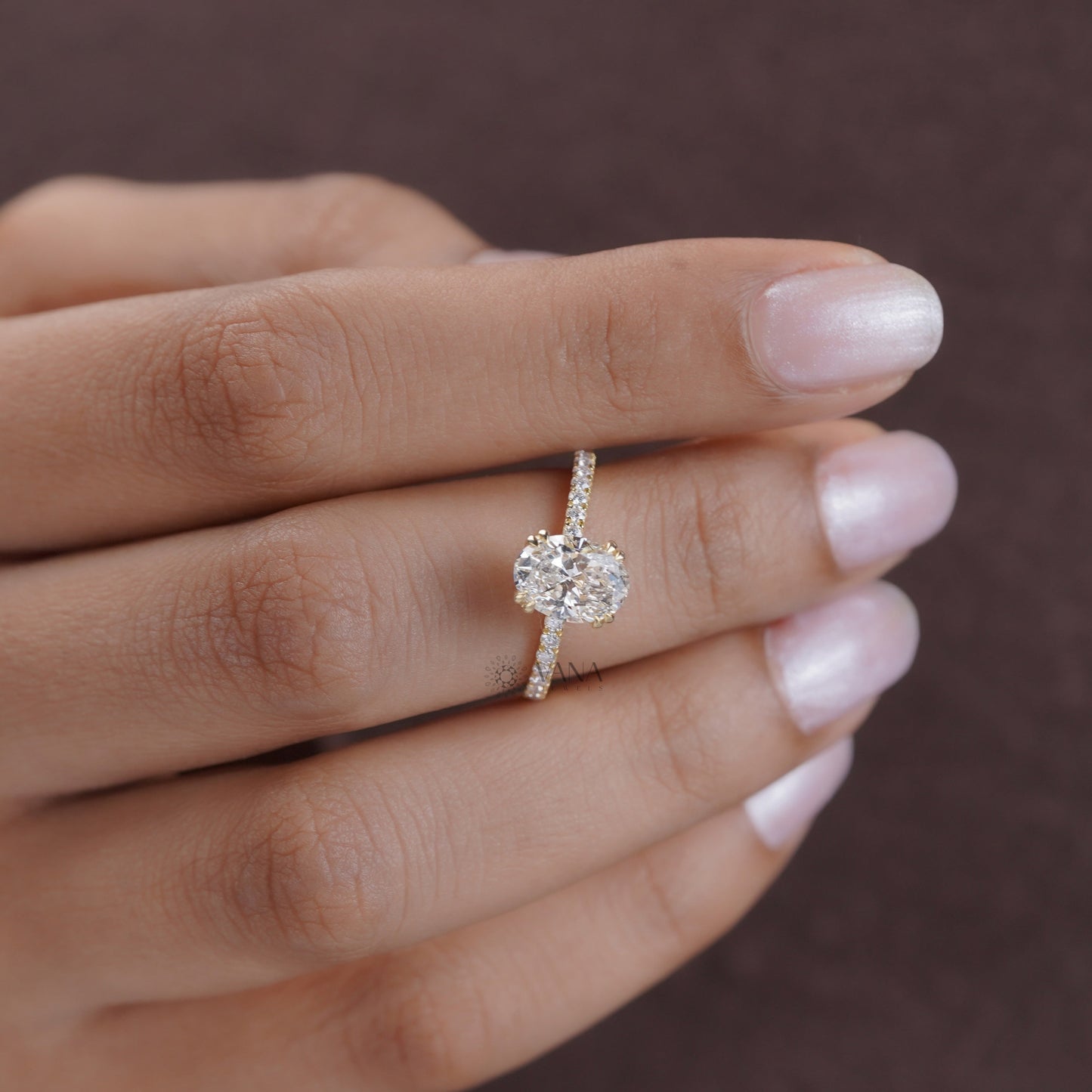 Designer moissanite ring in 14K gold with oval center, hidden halo, and modern prongs
