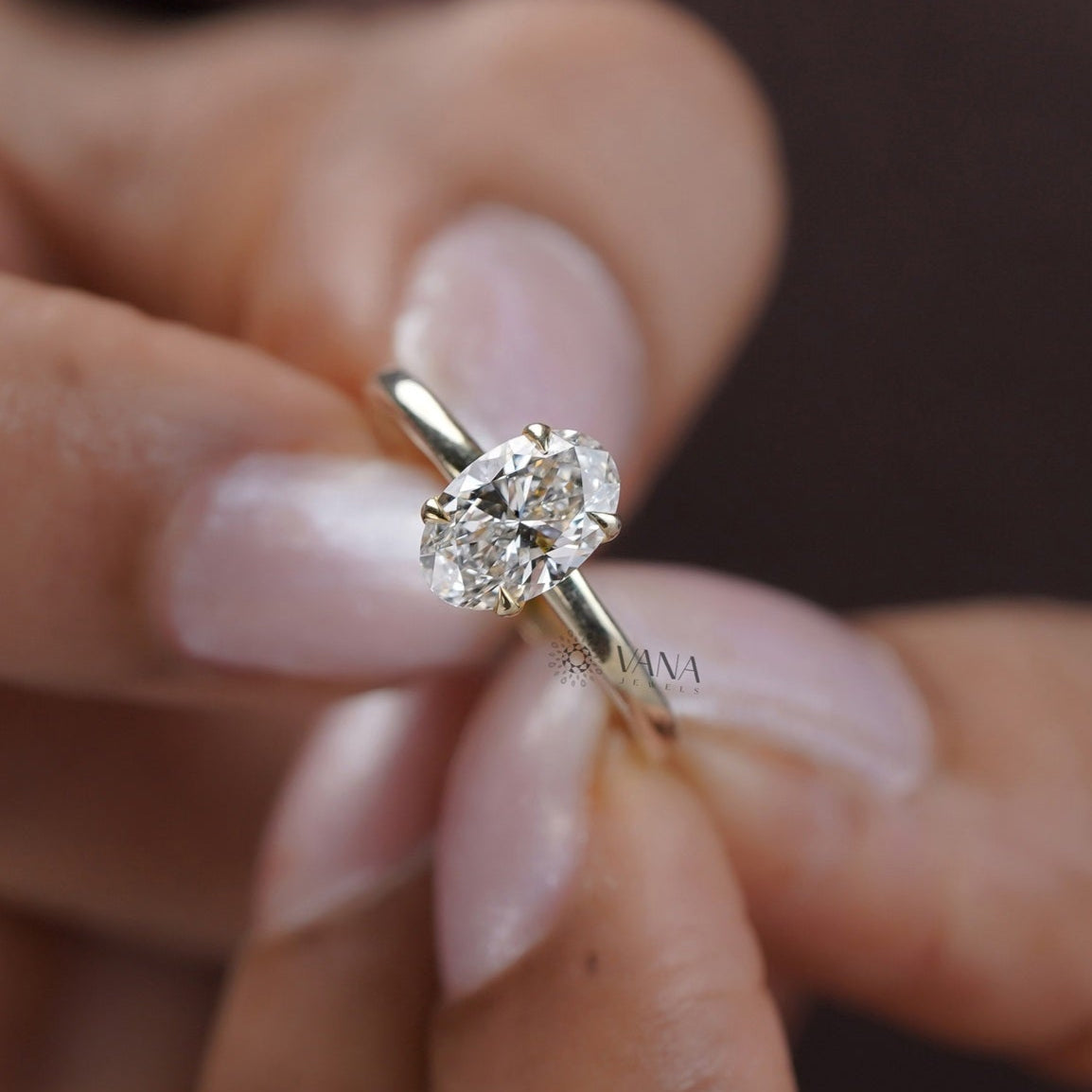 Yellow gold solitaire ring with center oval moissanite stone
