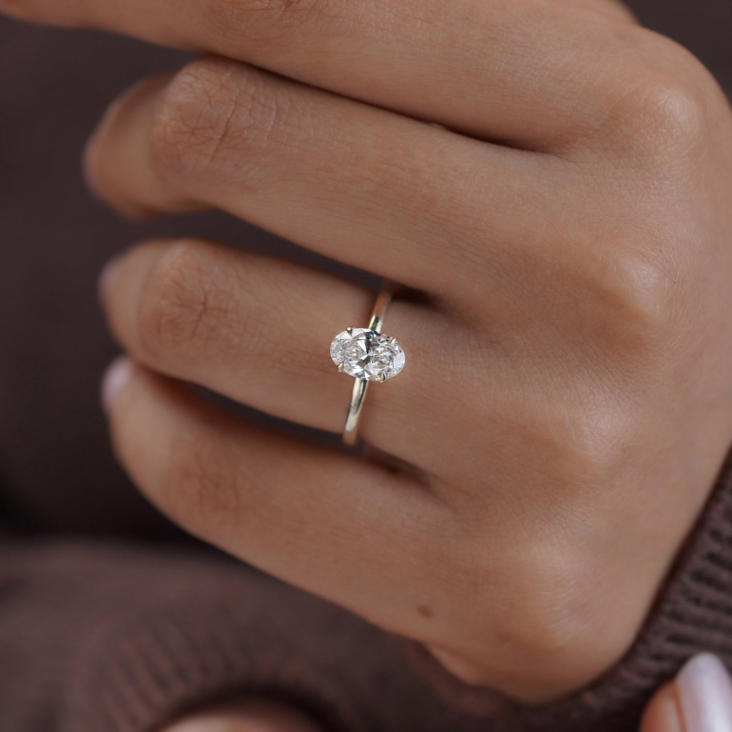 Sleek and simple oval solitaire moissanite ring in gold band