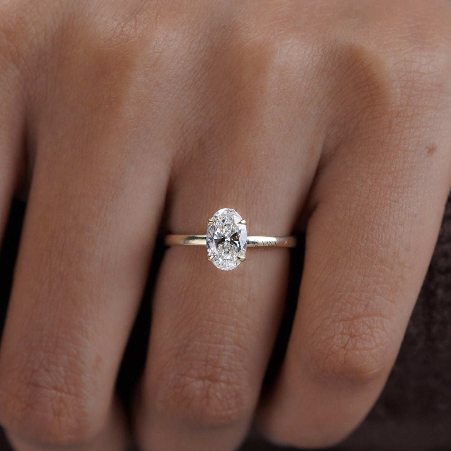 Solitaire engagement ring with oval moissanite and thin gold band