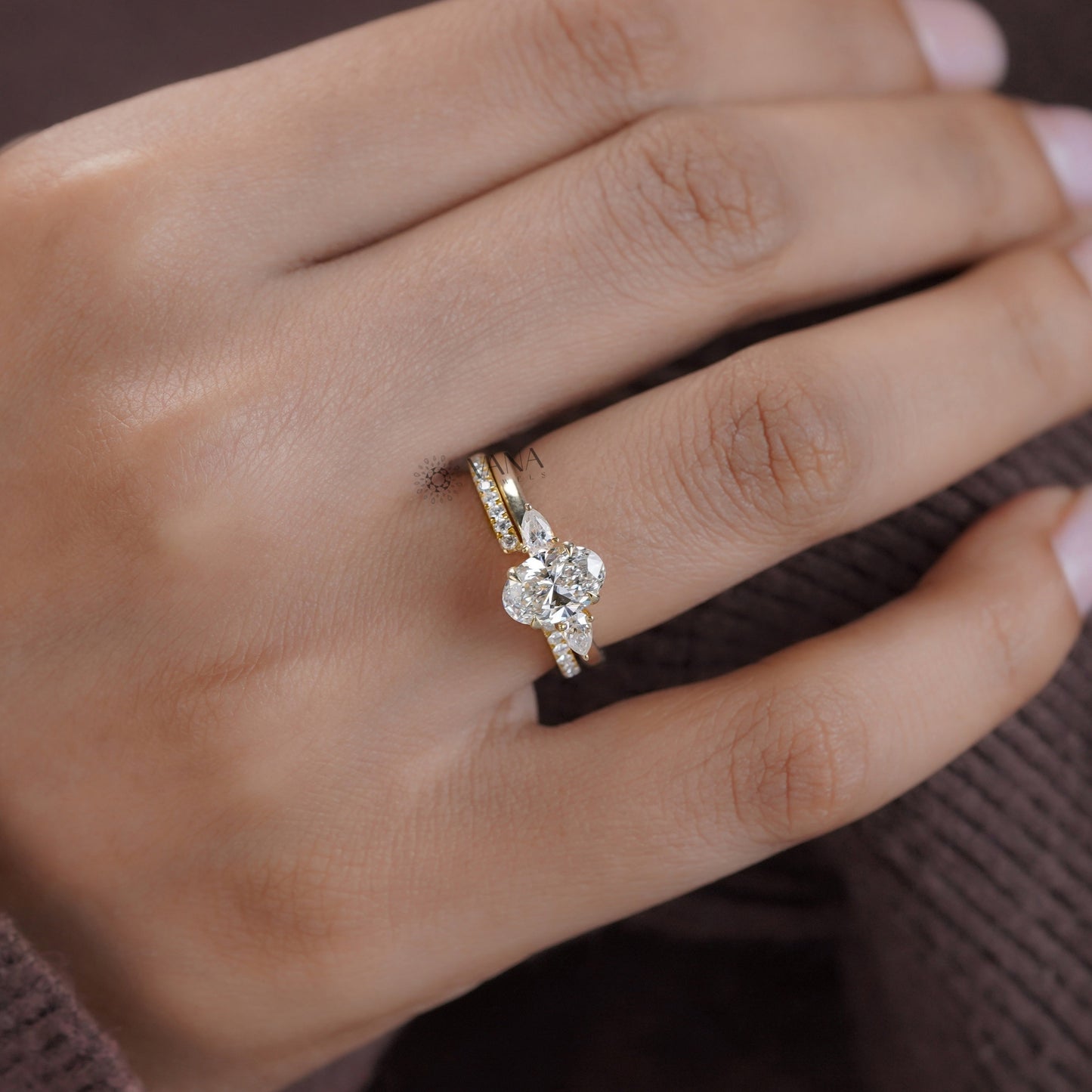 Oval cut moissanite engagement ring set with matching marquise round band
