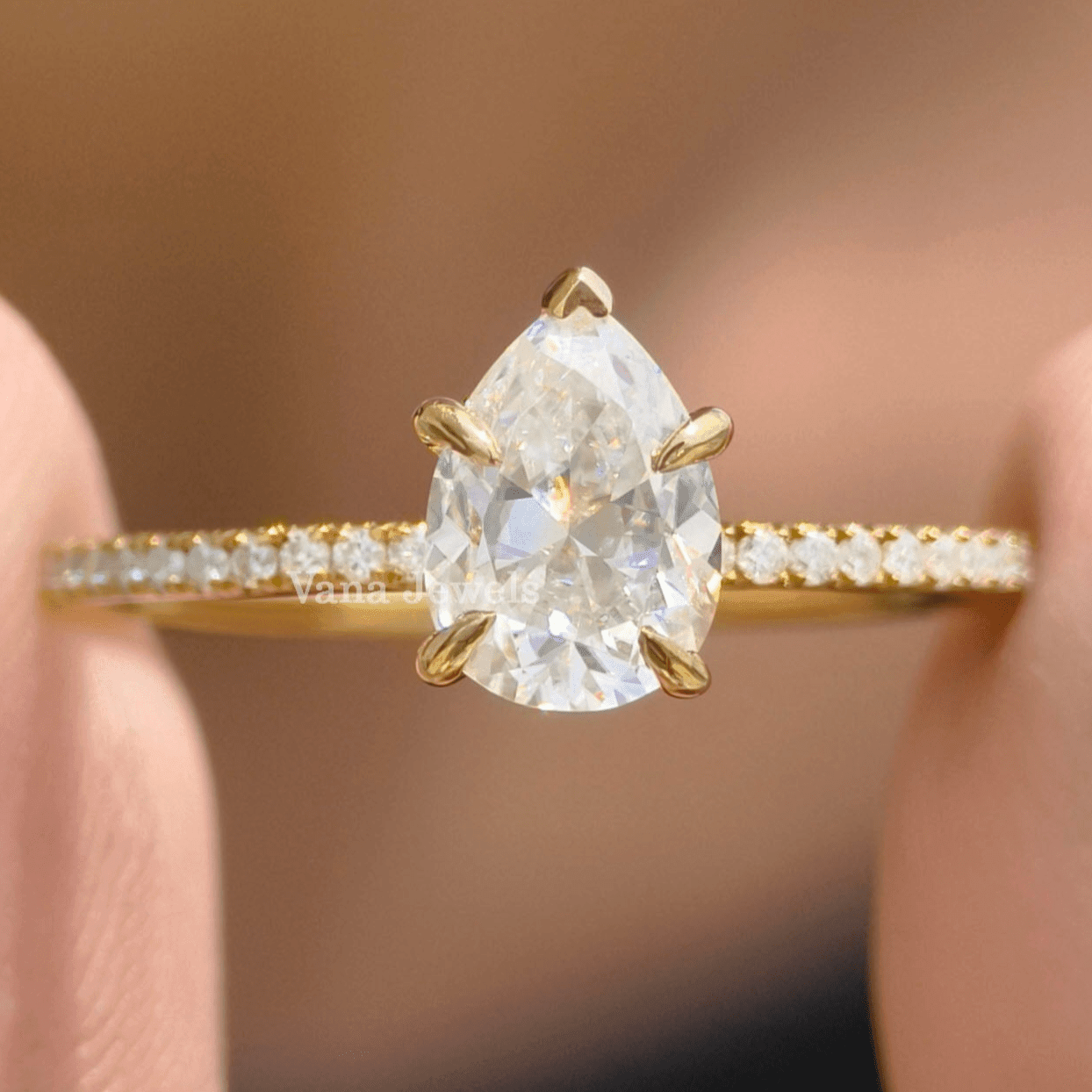 Pear cut moissanite engagement ring with pave set