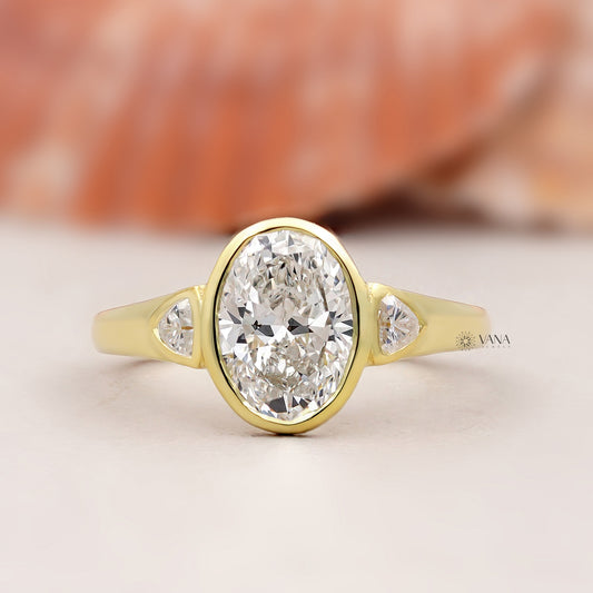 Oval Lab Grown Diamond Bezel Engagement Ring with Trillion Side Stones and Tapered Gold Band