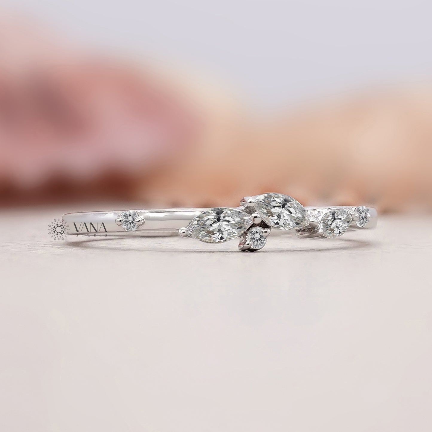 Delicate white gold bridal band featuring marquise diamonds
