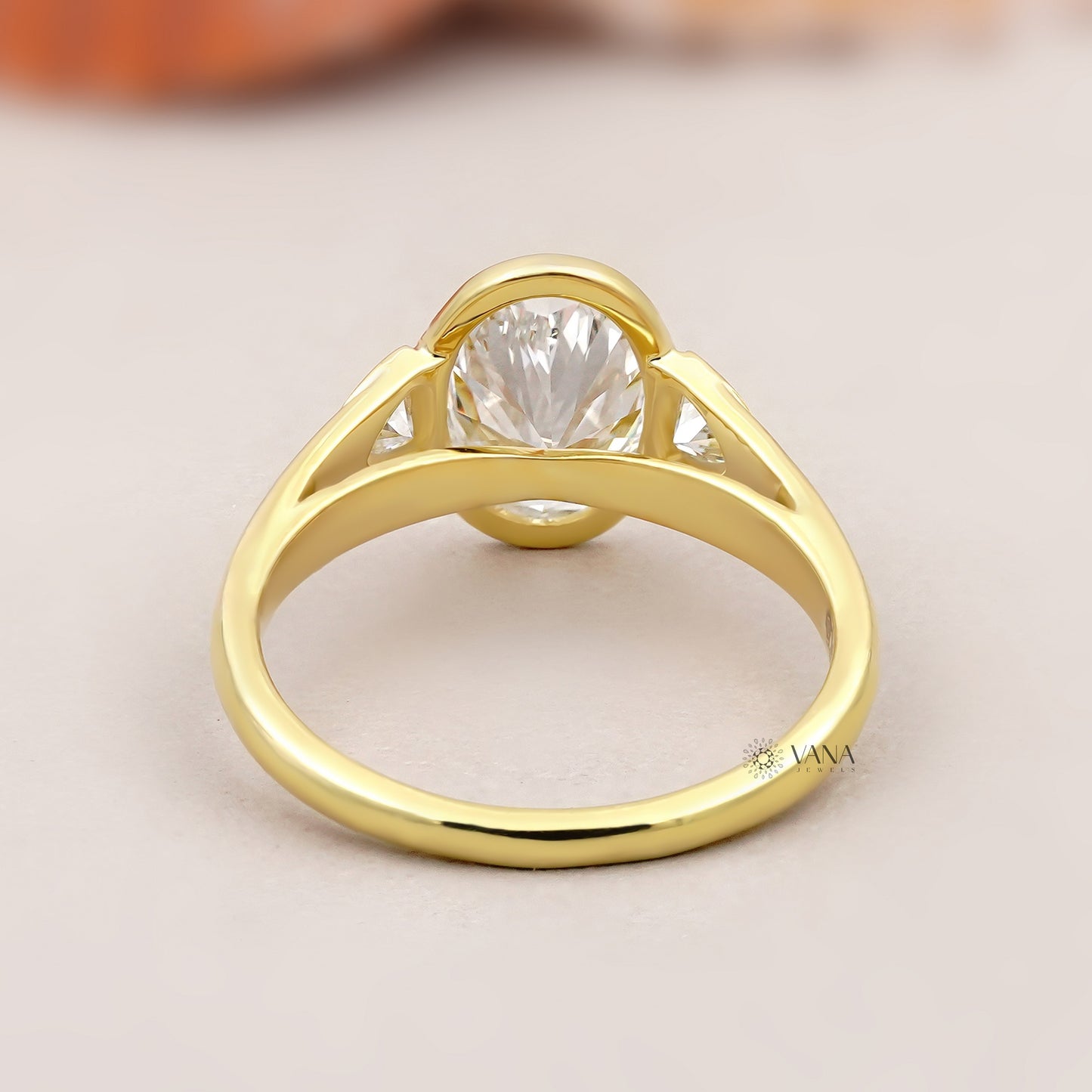 Oval Lab Grown Diamond Bezel Engagement Ring with Trillion Side Stones and Tapered Gold Band