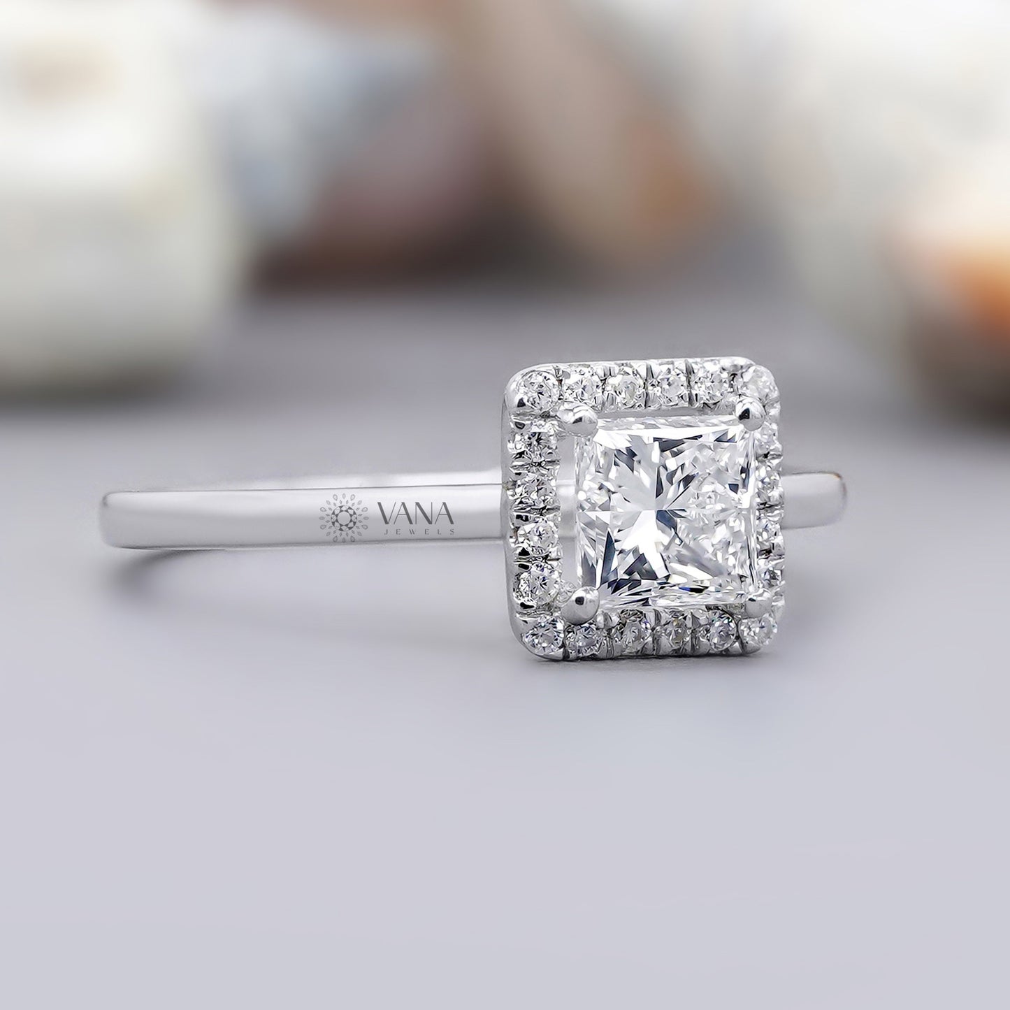 Diamond ring with a square halo on a light gray background