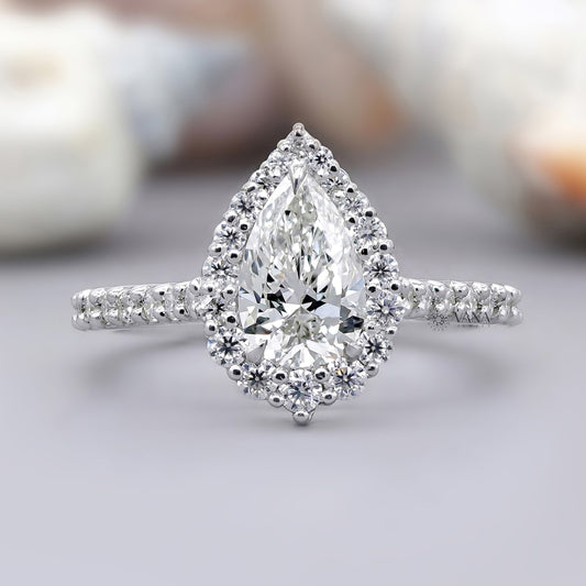 Pear cut moissanite halo engagement ring with pave setting in white gold