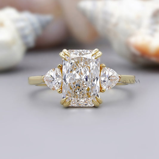 Radiant cut moissanite engagement ring with trillion cut side stones in yellow gold