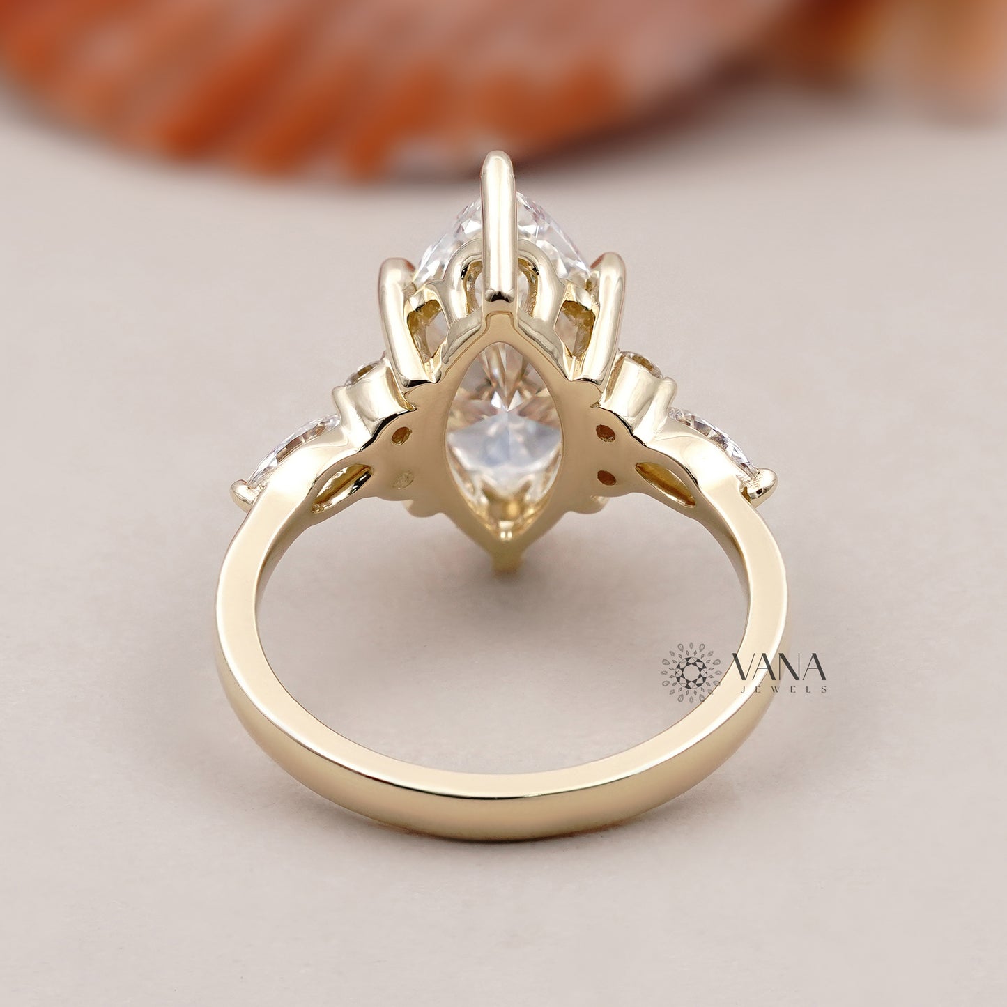 Vintage-inspired marquise shape engagement ring with round brilliant side diamonds