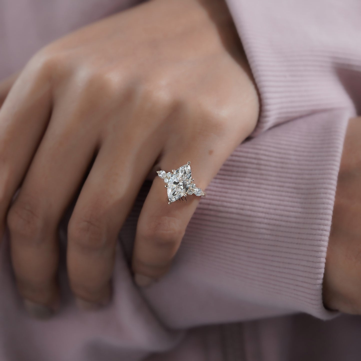 Vintage-inspired marquise shape engagement ring with round brilliant side diamonds