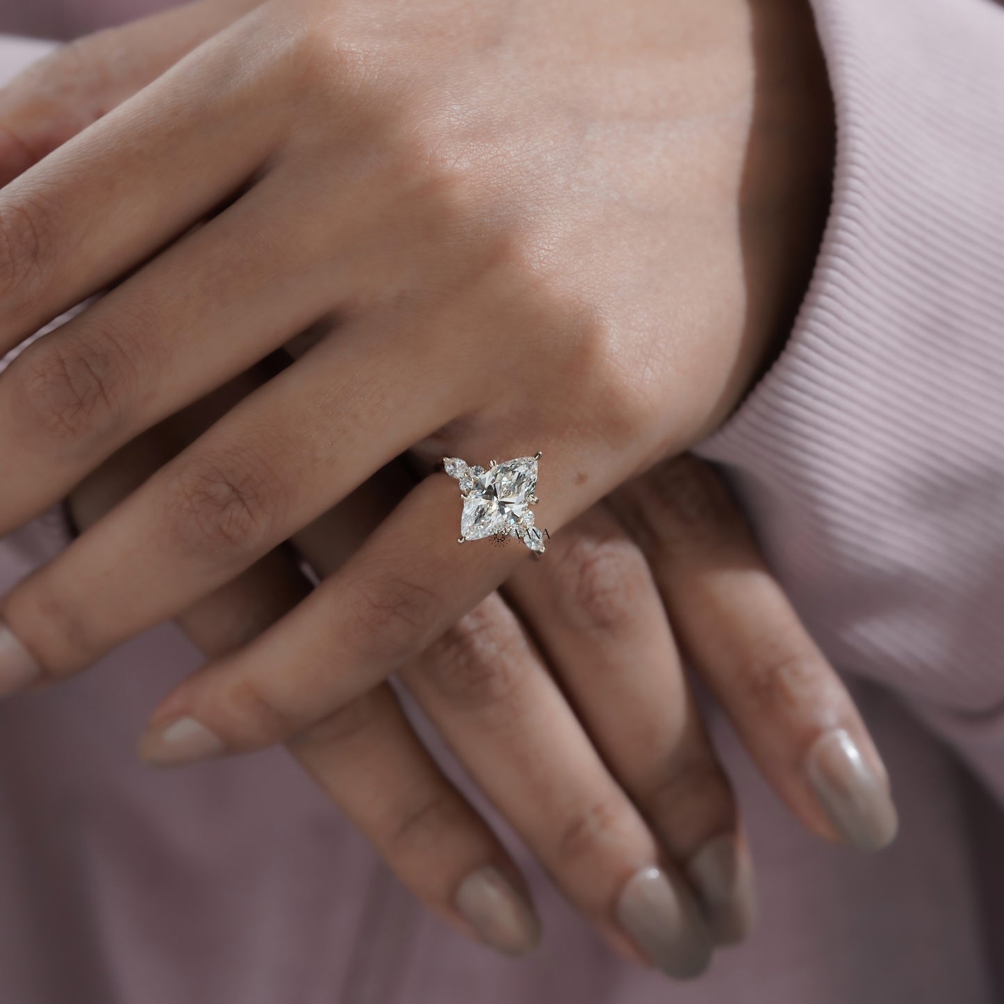 Vintage-inspired marquise shape engagement ring with round brilliant side diamonds