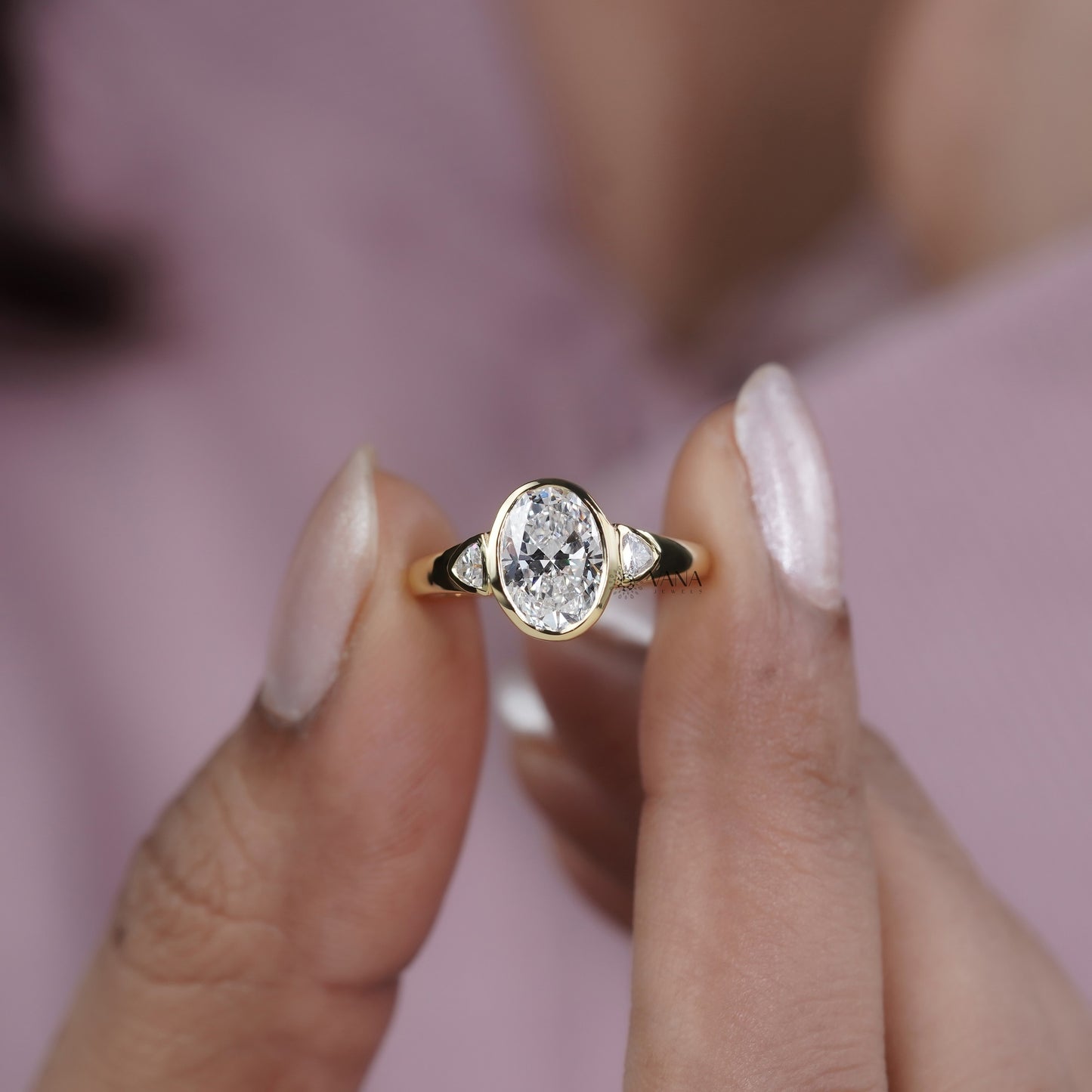 Oval Cut Moissanite Three Stone Bezel Set Engagement Ring in Yellow Gold