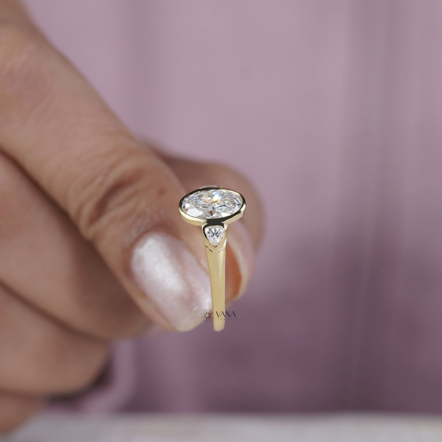 Oval Cut Moissanite Three Stone Bezel Set Engagement Ring in Yellow Gold