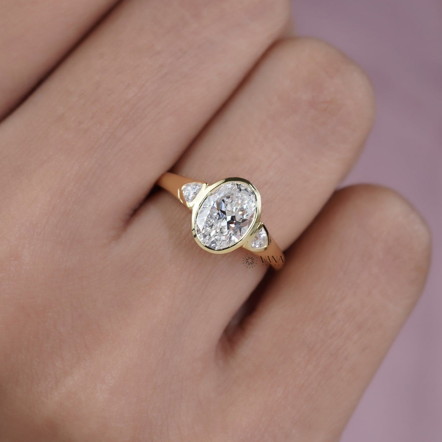 Oval Lab Grown Diamond Bezel Engagement Ring with Trillion Side Stones and Tapered Gold Band