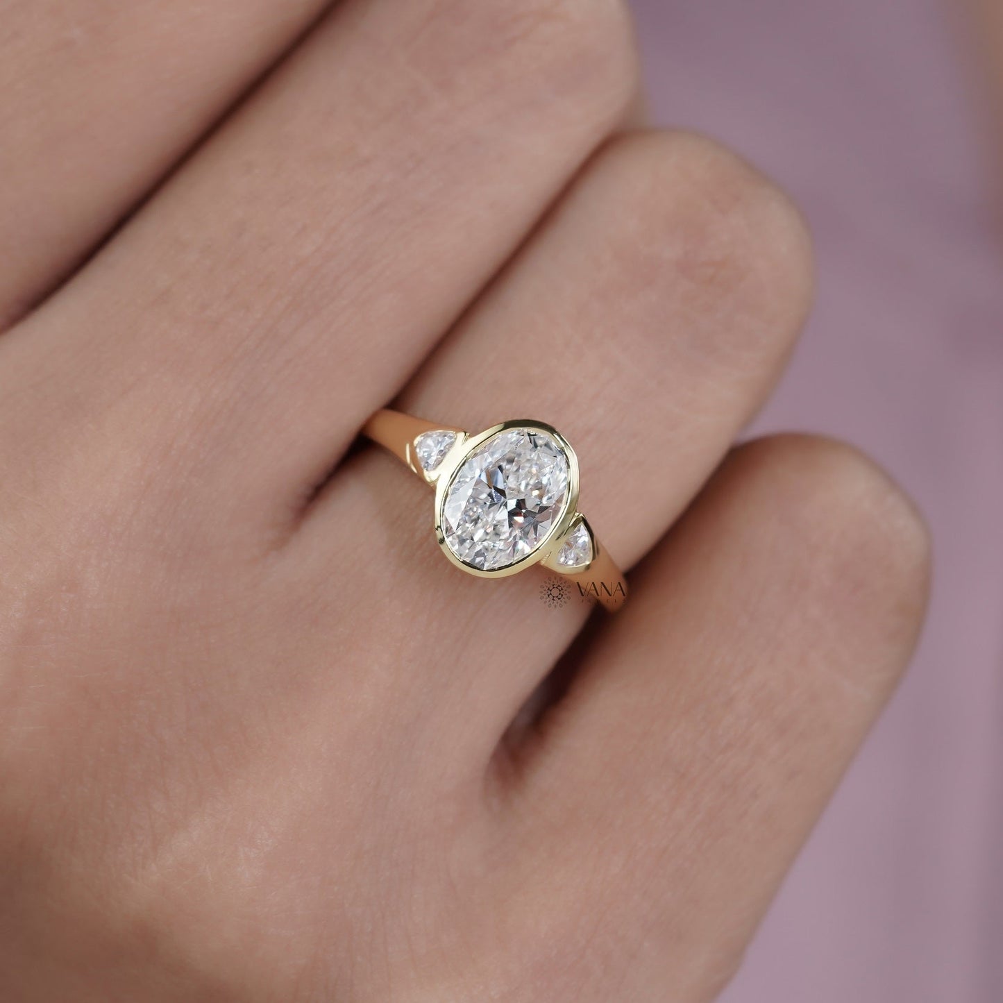 Oval Cut Moissanite Three Stone Bezel Set Engagement Ring in Yellow Gold