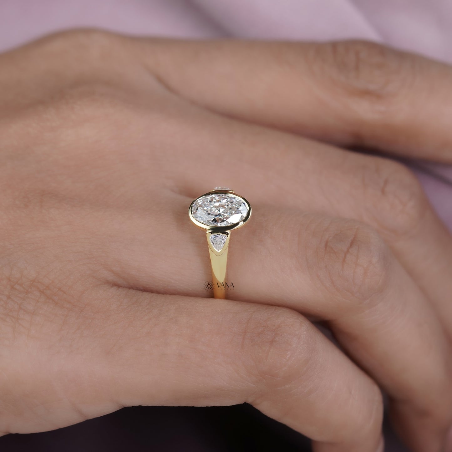 Oval Lab Grown Diamond Bezel Engagement Ring with Trillion Side Stones and Tapered Gold Band