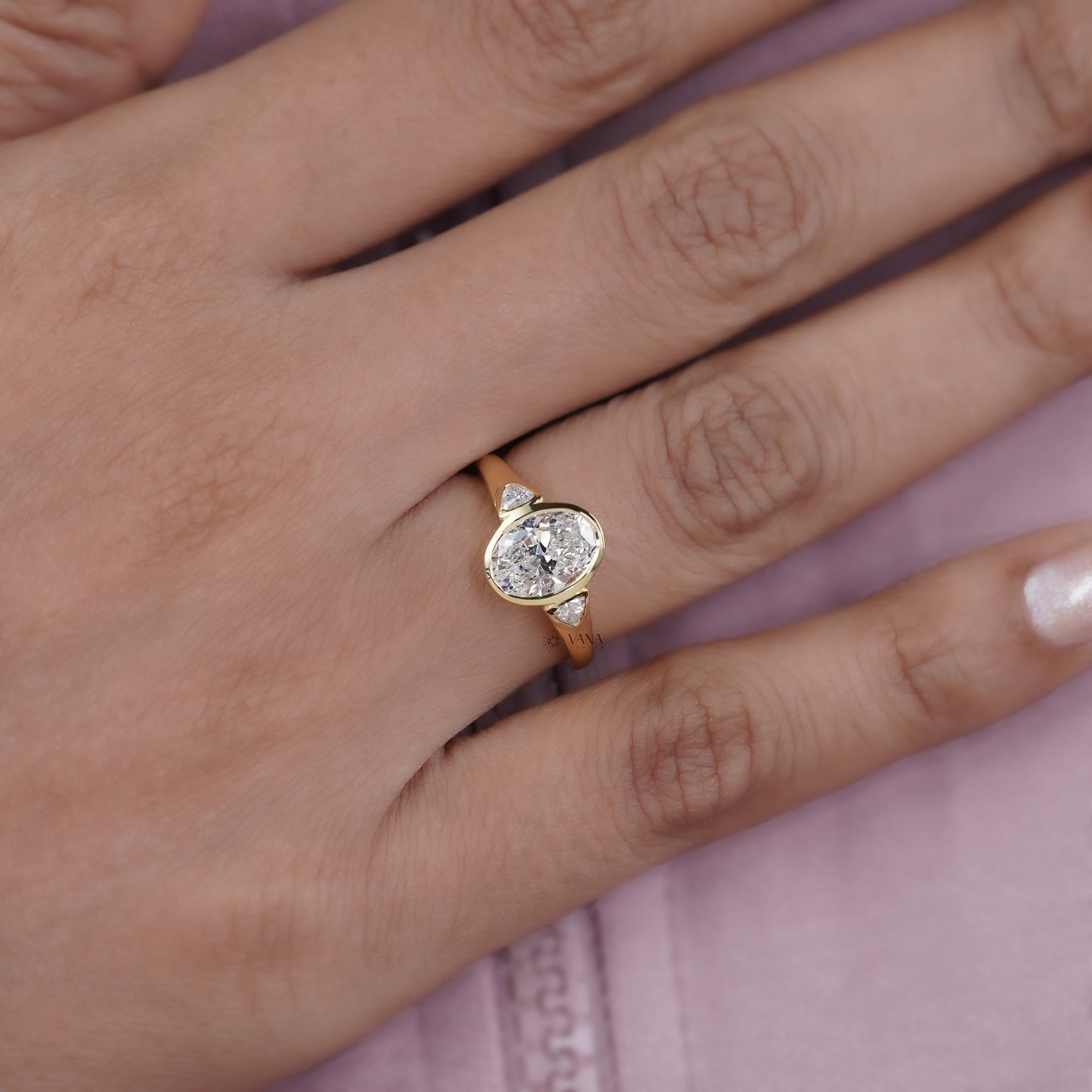 Oval Cut Moissanite Three Stone Bezel Set Engagement Ring in Yellow Gold