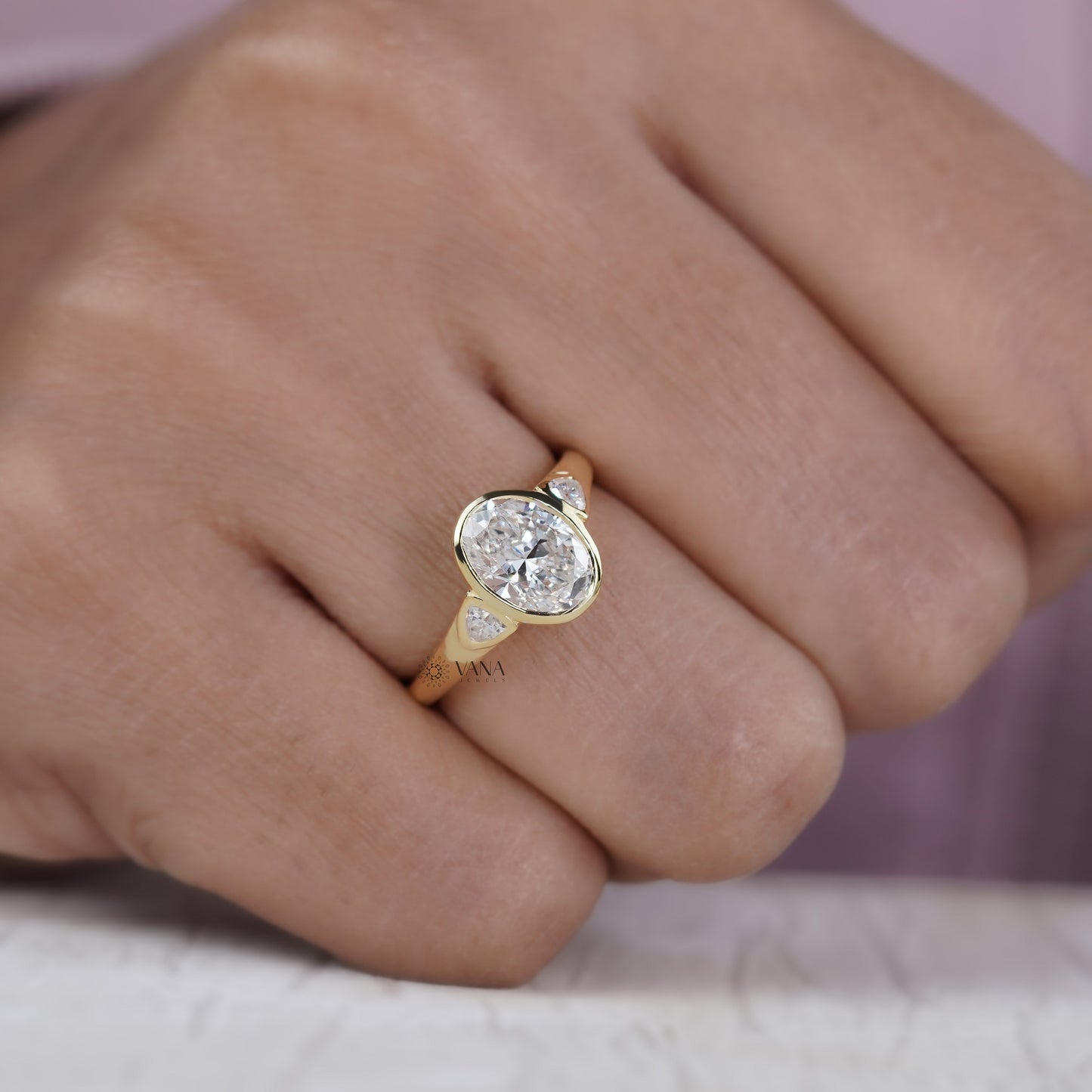 Oval Lab Grown Diamond Bezel Engagement Ring with Trillion Side Stones and Tapered Gold Band