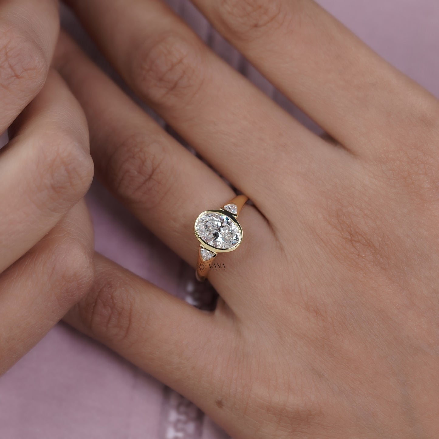 Oval Cut Moissanite Three Stone Bezel Set Engagement Ring in Yellow Gold