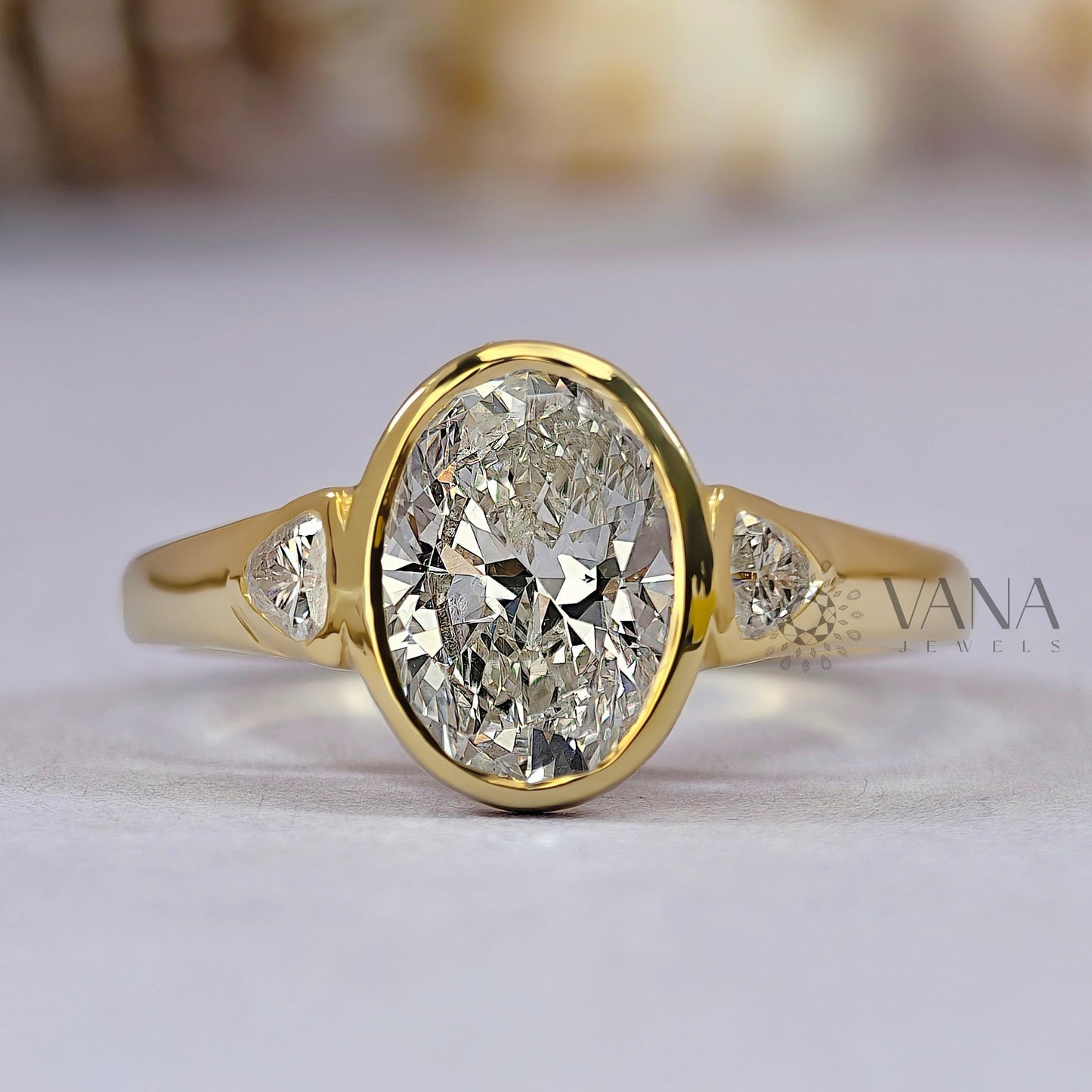 Oval Cut Moissanite Three Stone Bezel Set Engagement Ring in Yellow Gold