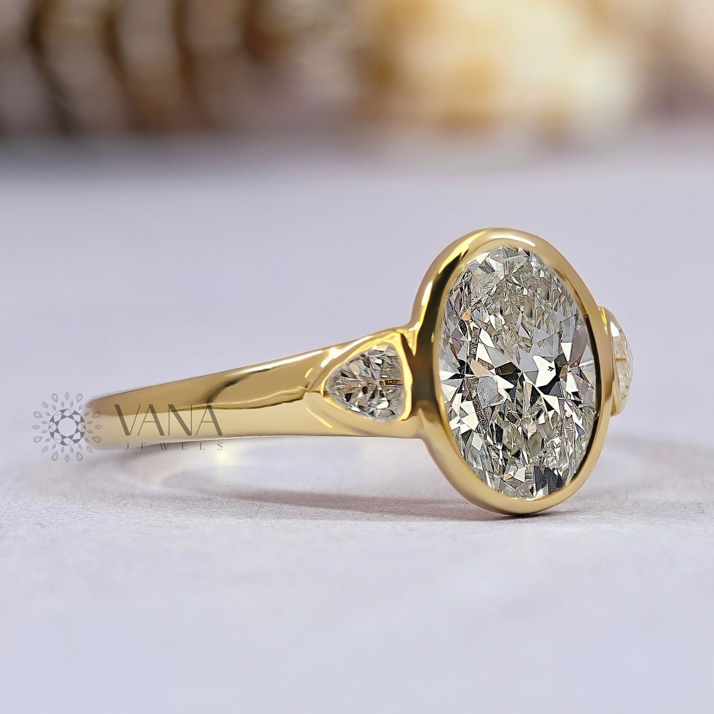 Oval Cut Moissanite Three Stone Bezel Set Engagement Ring in Yellow Gold