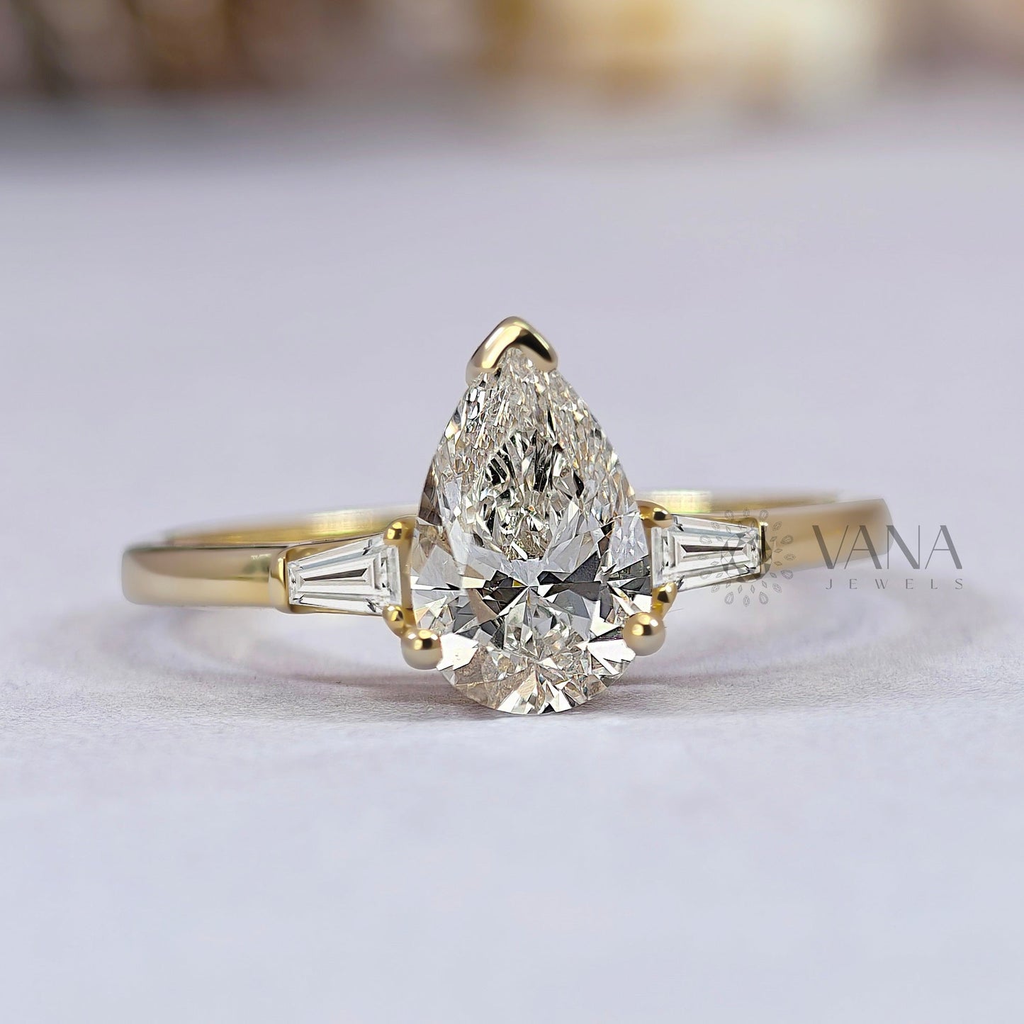 Pear Cut Moissanite Three Stone Engagement Ring with Tapered Baguette Side Stones