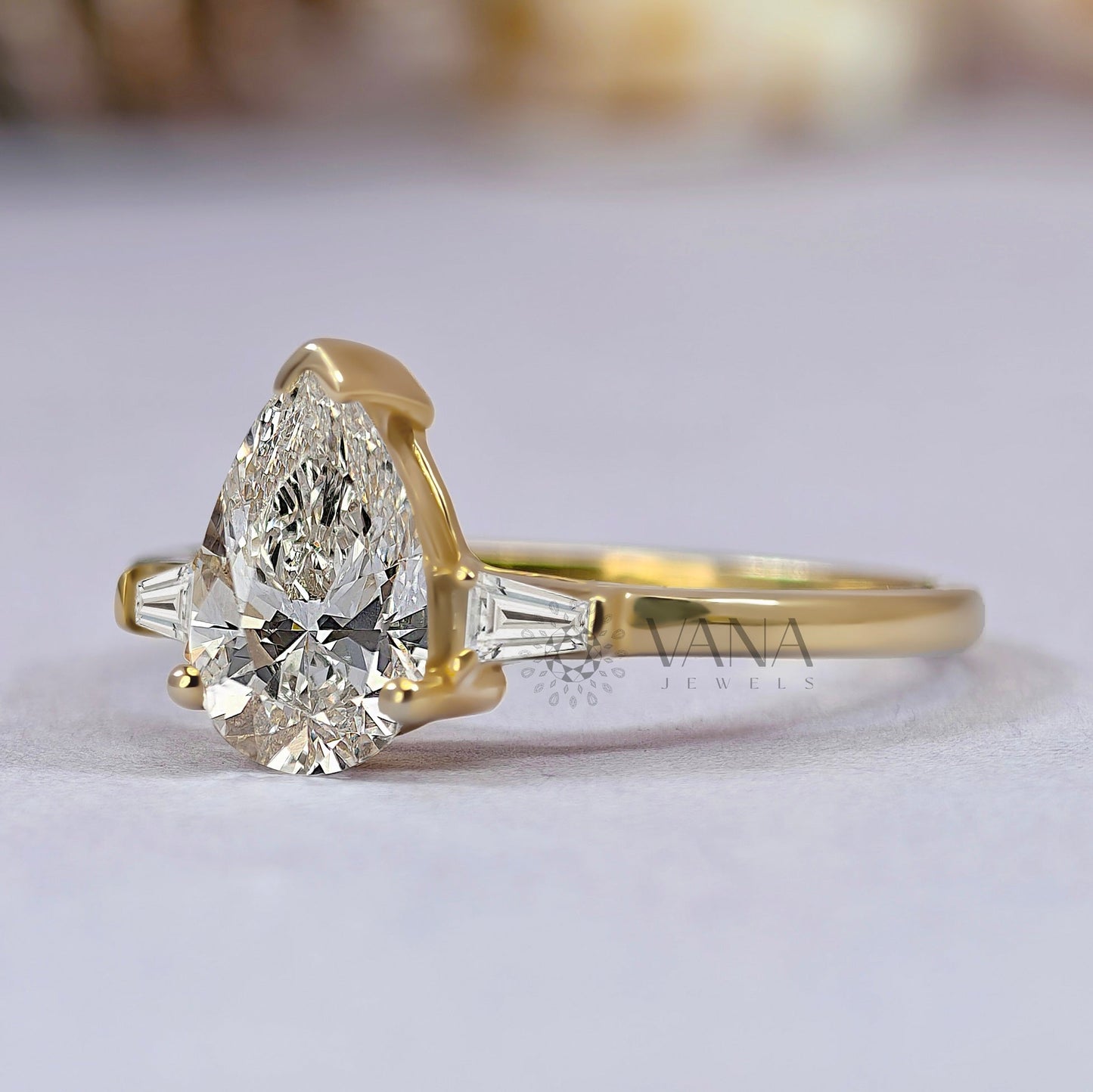 Pear Cut Moissanite Three Stone Engagement Ring with Tapered Baguette Side Stones