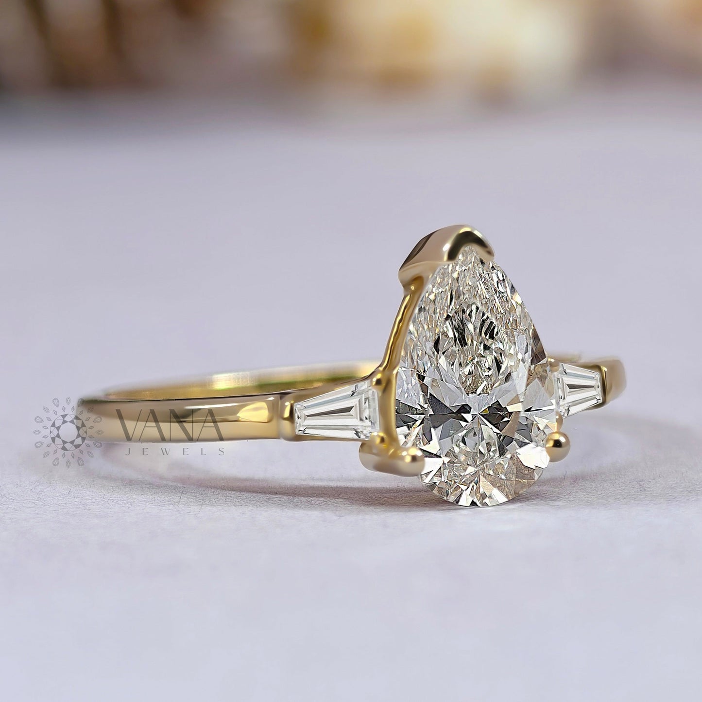 Pear Cut Moissanite Three Stone Engagement Ring with Tapered Baguette Side Stones