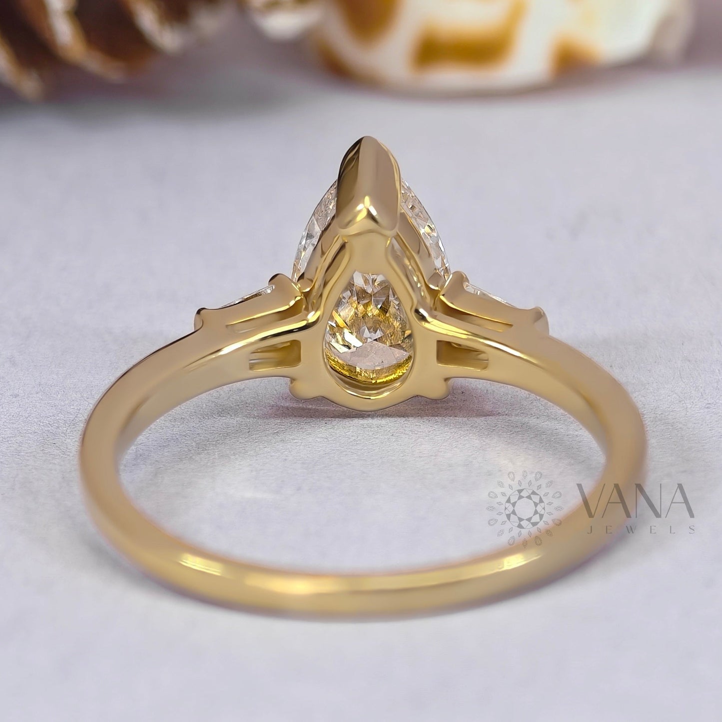 Pear Cut Moissanite Three Stone Engagement Ring with Tapered Baguette Side Stones