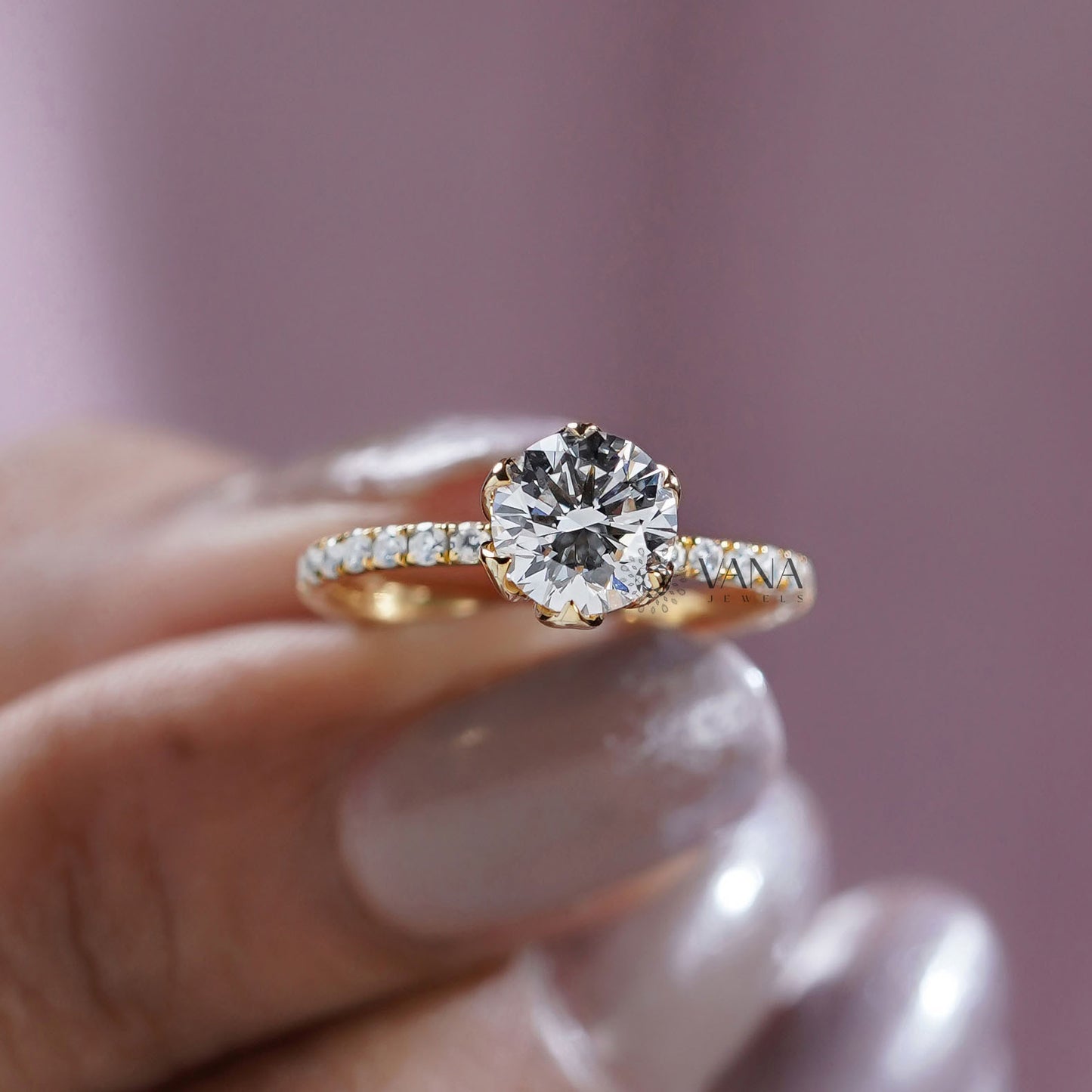 Gold ring with a large diamond held by a hand