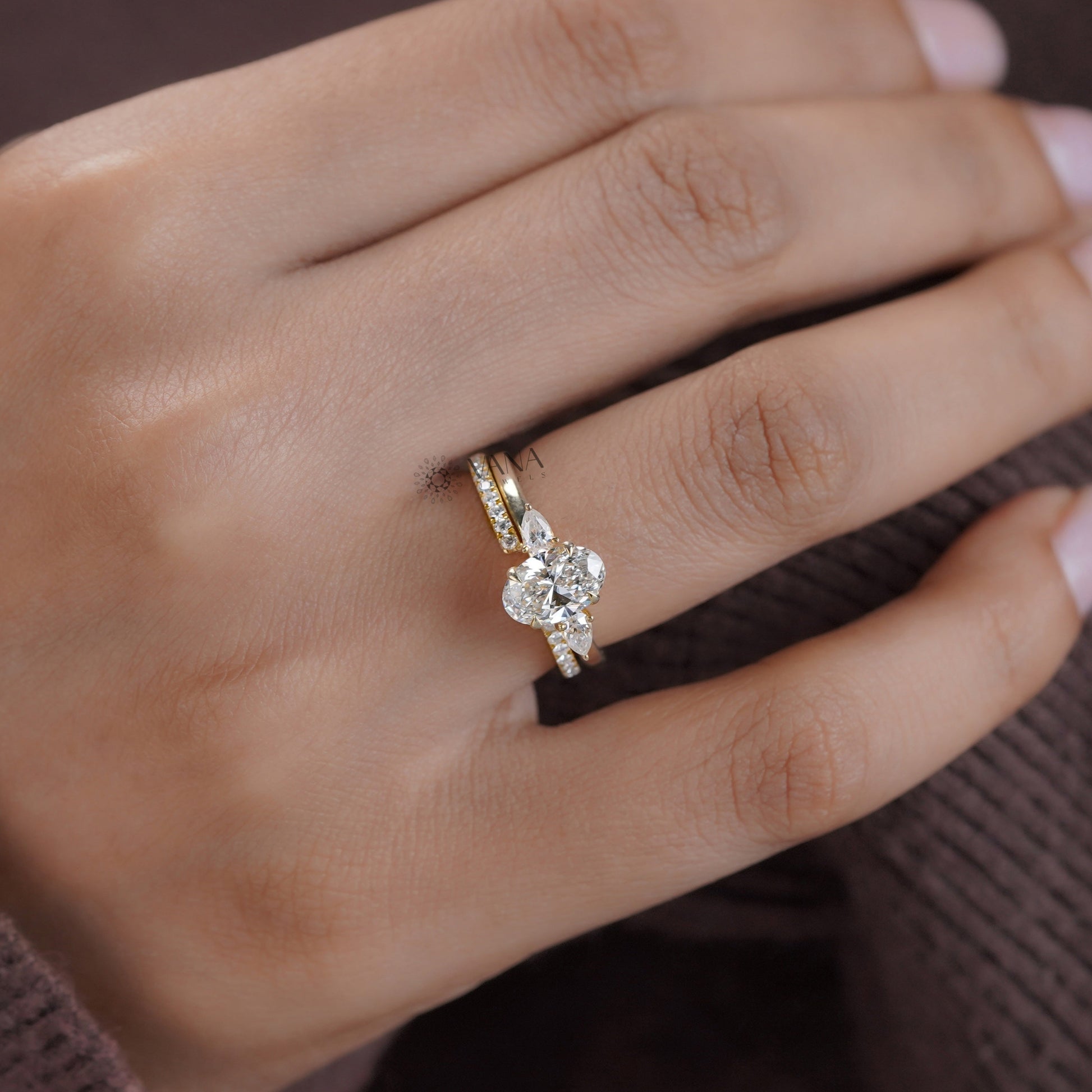 Oval cut moissanite engagement ring set with matching marquise round band